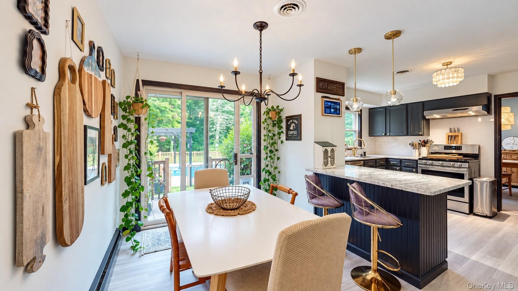 Gourmet kitchen with dark cabinetry, stainless steel appliances, and a central island with a light-toned countertop