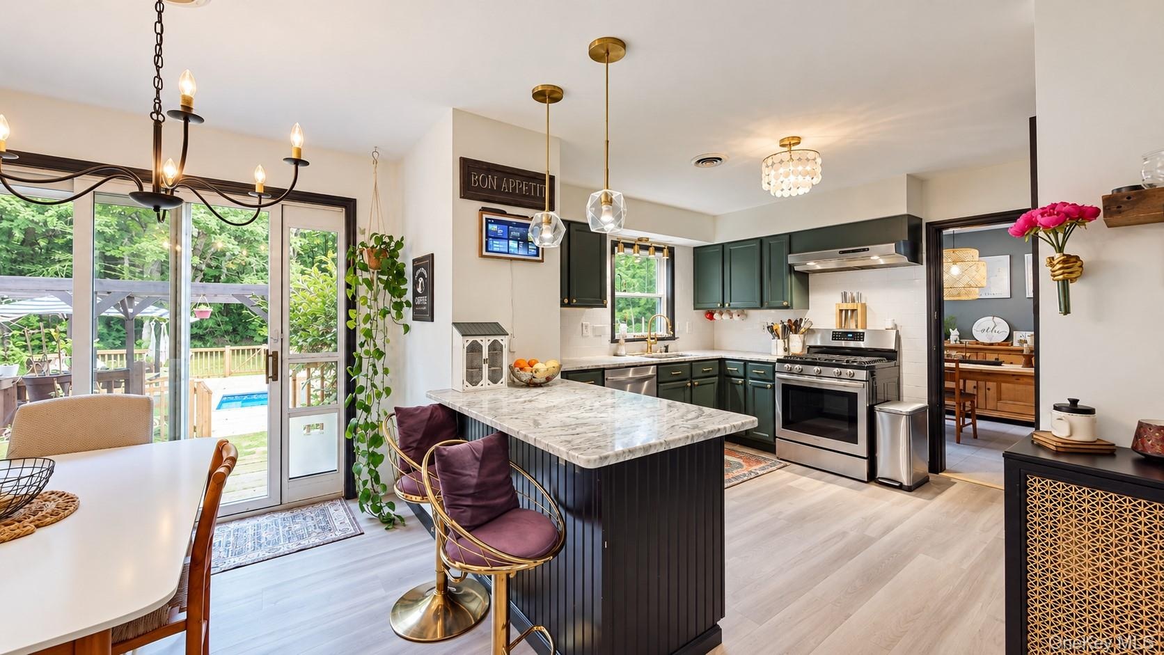 Kitchen featuring a center island with a stone countertop, recessed lighting, and stainless steel appliances