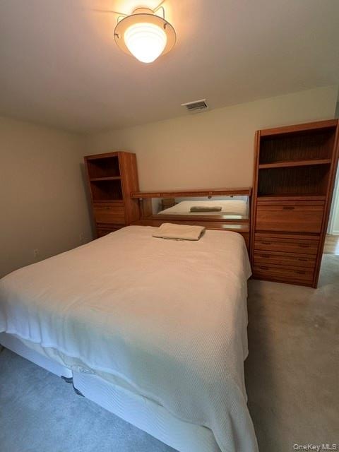 Built-in headboard cabinetry with integrated shelving and drawer storage