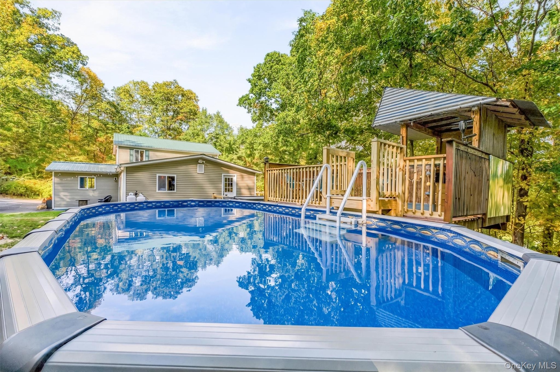 above - ground swimming pool featuring a classic blue interior, vinyl liner construction, and integrated deck decking