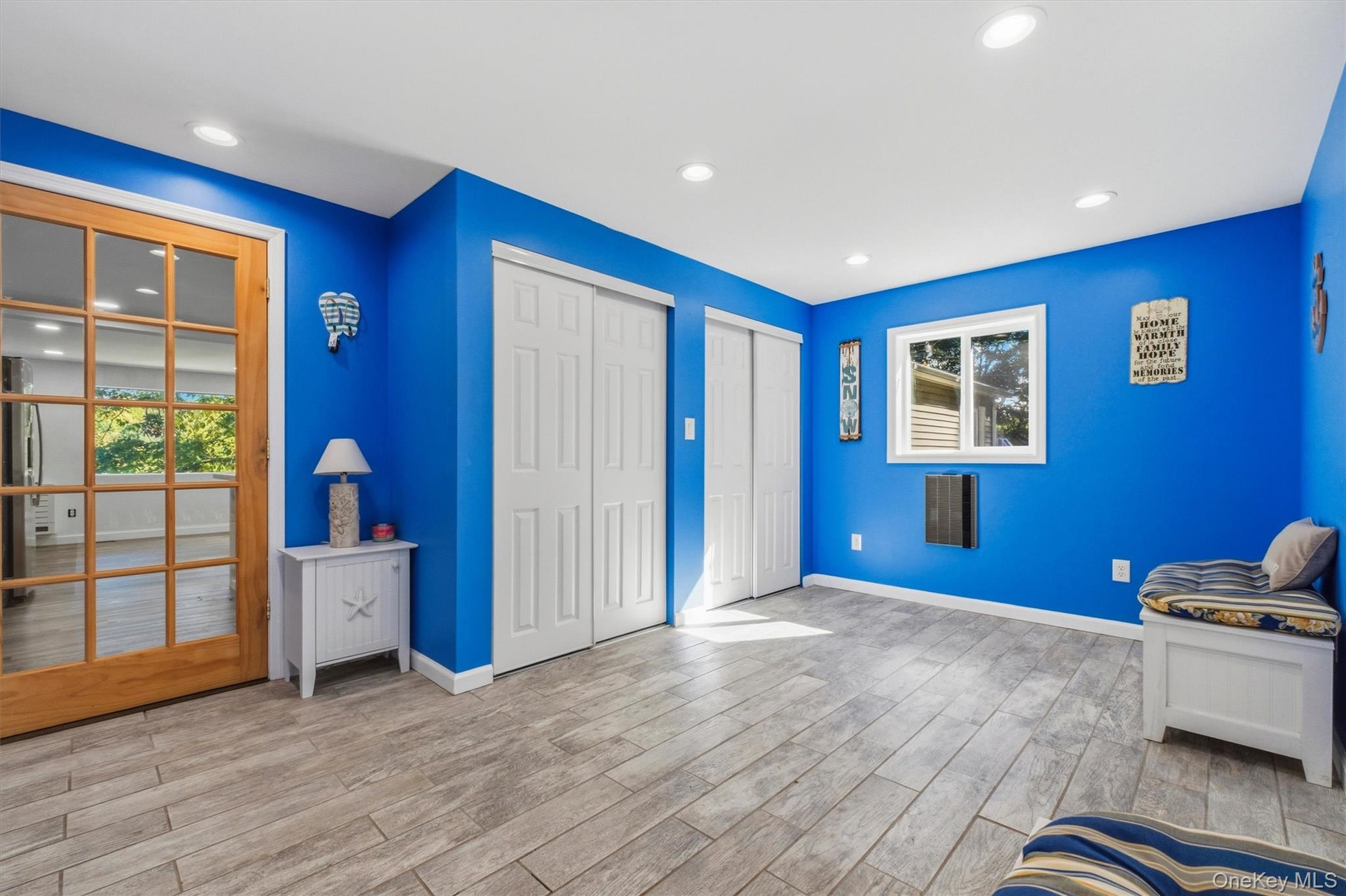 Recessed lighting, wood-finish flooring, French doors with divided lites, built-in storage bench, and a window with trim