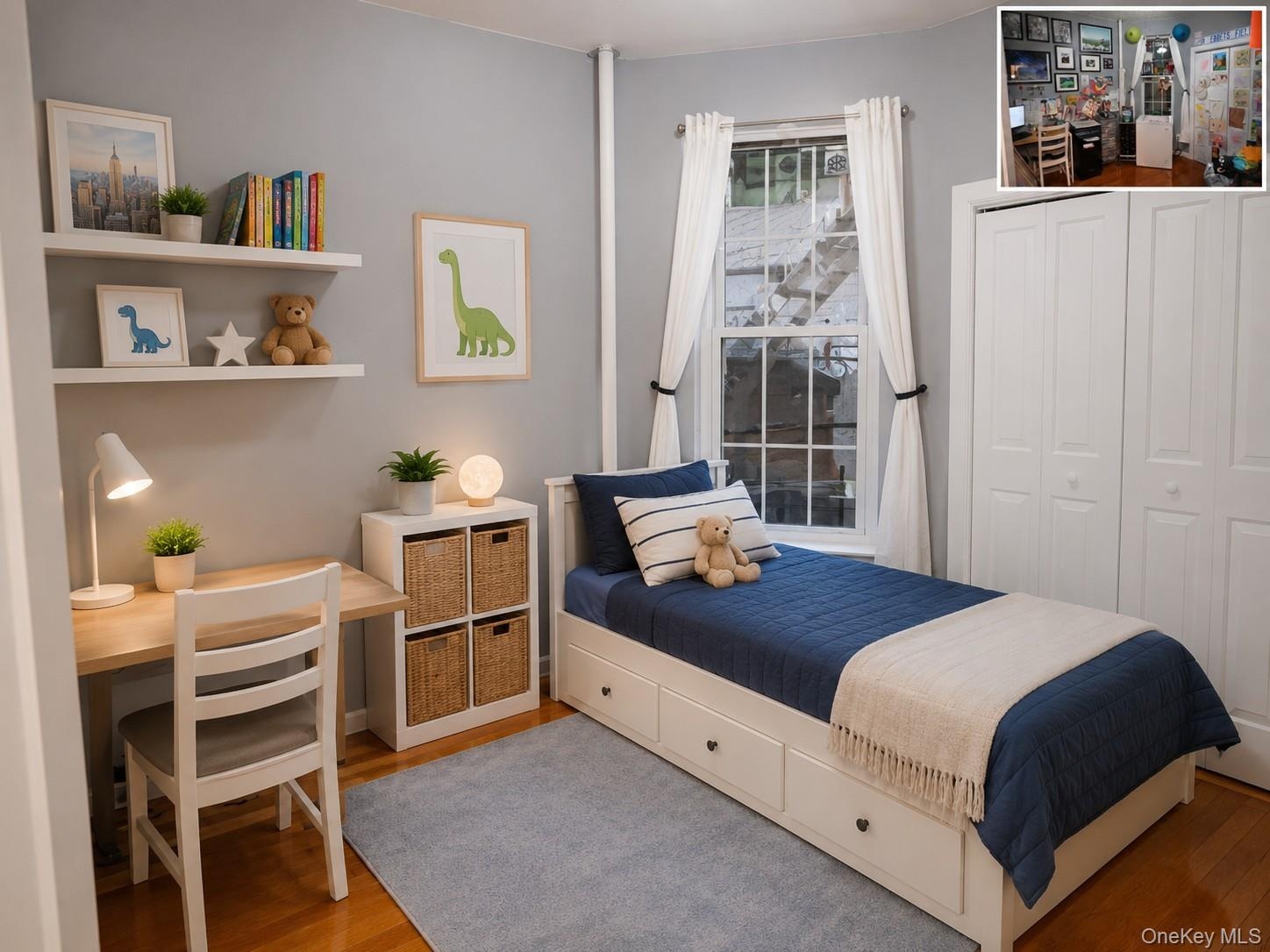 Light-filled bedroom featuring wood-finish flooring, a double window with white trim, built-in shelving, and a white bi-fold closet (virtually staged)
