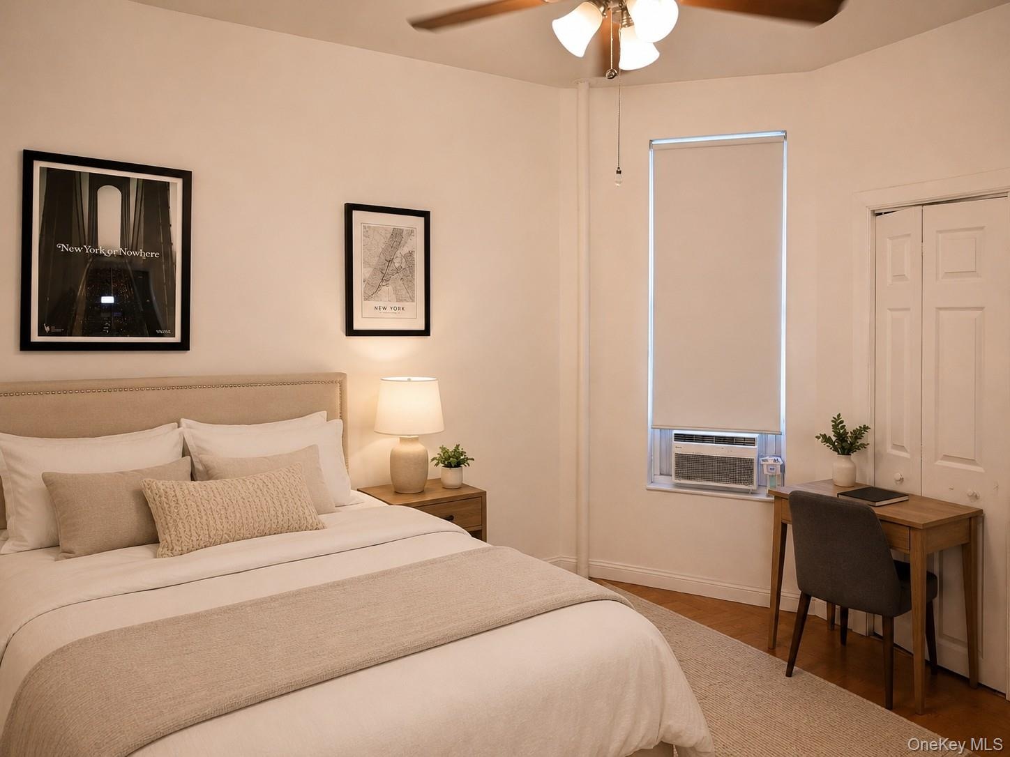 Bedroom featuring a ceiling fan with integrated lighting, wood-finish flooring, and a window with a roller blind (virtually staged)