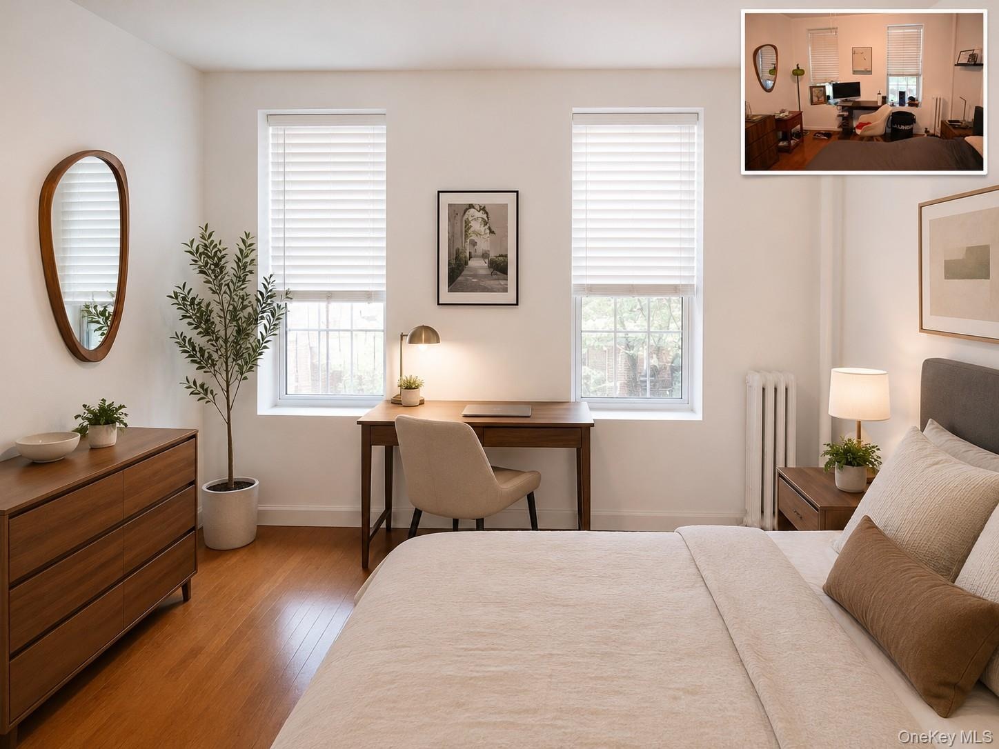 Room featuring two windows with white blinds, wood-finish flooring, and a built-in radiator (virtually staged)