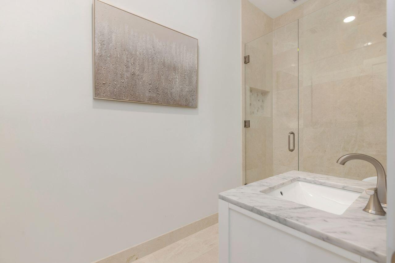Guest Bathroom, white vanity with a marble countertop and undermount sink