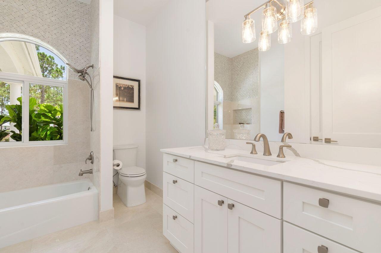 Vanity area featuring a dual sink with a white countertop and brushed nickel fixtures