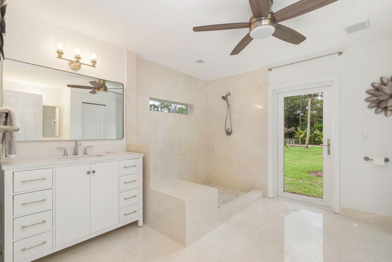 Contemporary Primary bathroom featuring a spacious walk-in shower with a built-in bench and a horizontal privacy window