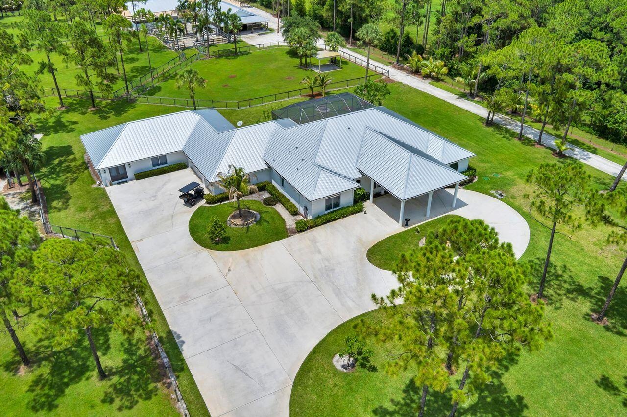 Spacious single-story residence with a metal roof and a circular drive