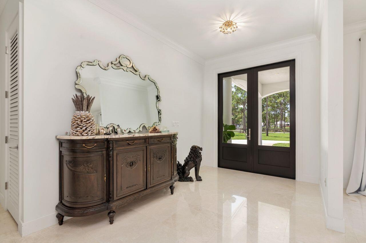 Double entry doors with glass panels and dark wood framing