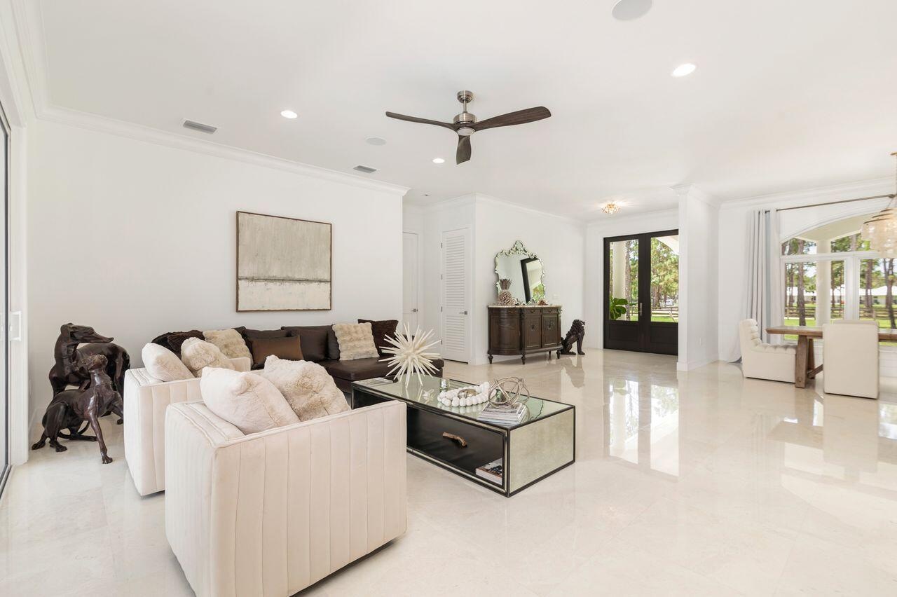 Expansive living area with high ceilings, recessed lighting.