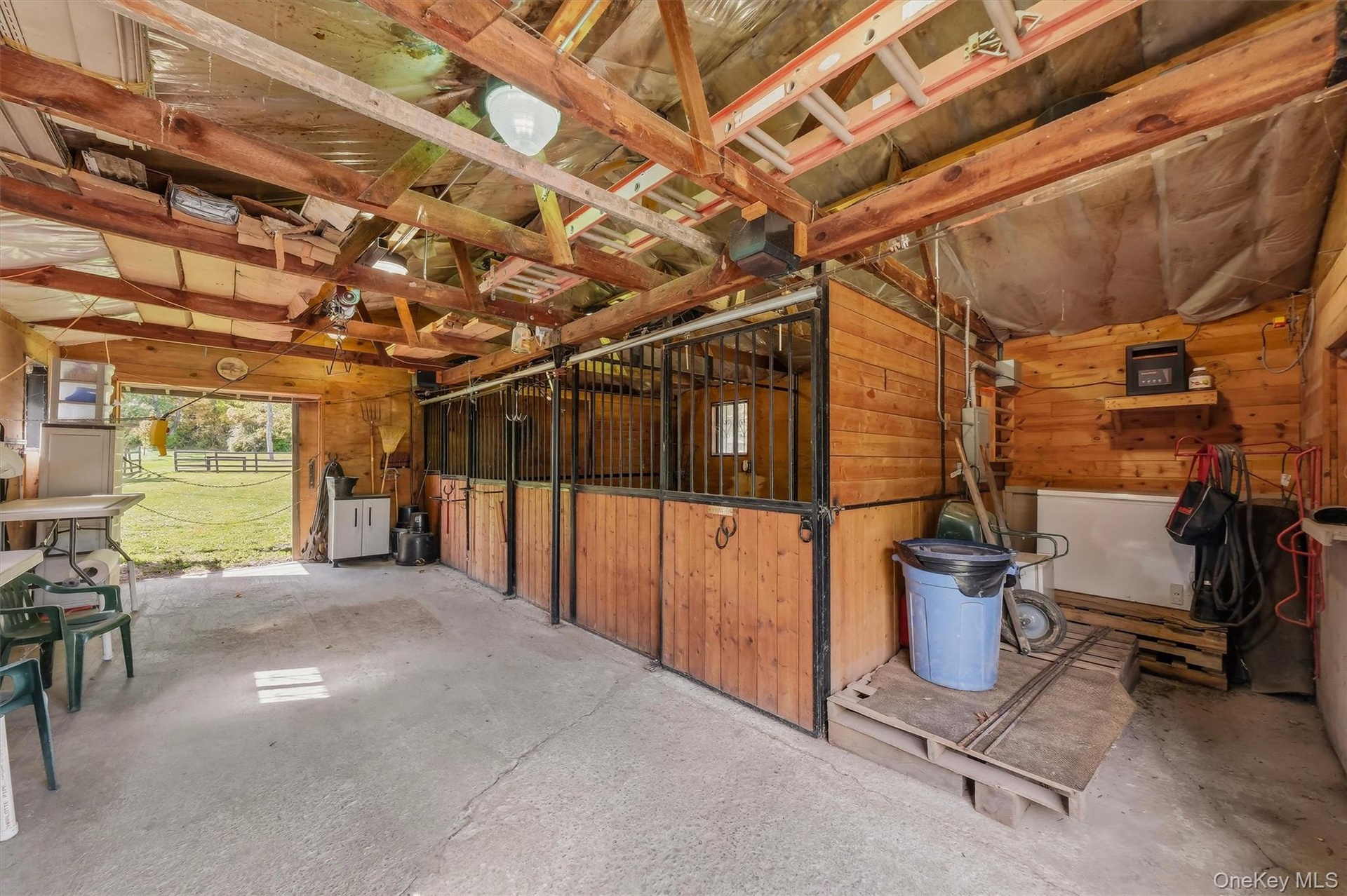 The barn includes 3 stalls, a tack/feed area, electric and a passage door.