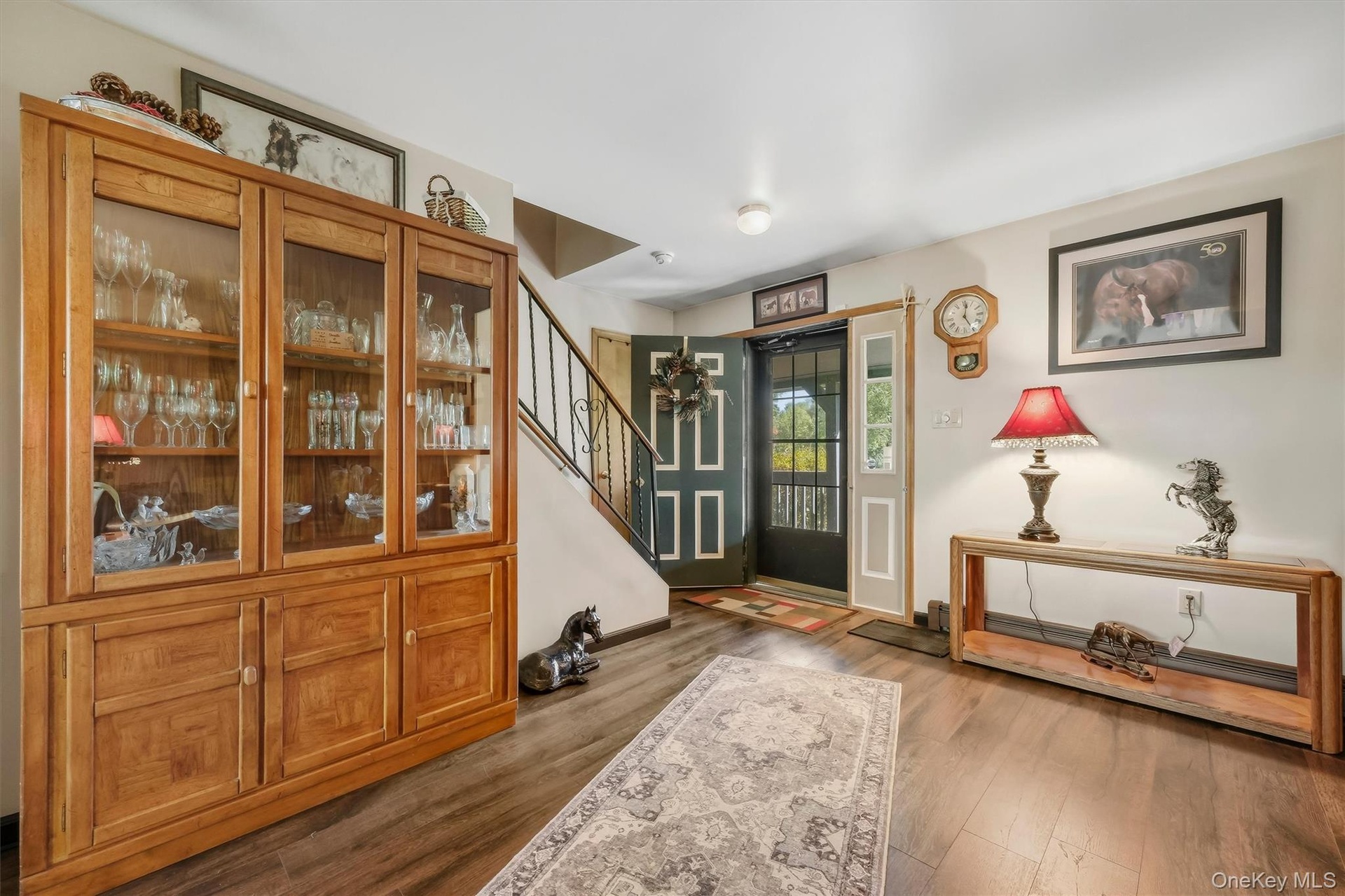 Front entry into the home brings you into the spacious living room.  Walnut LVP lends a farmhouse feel.