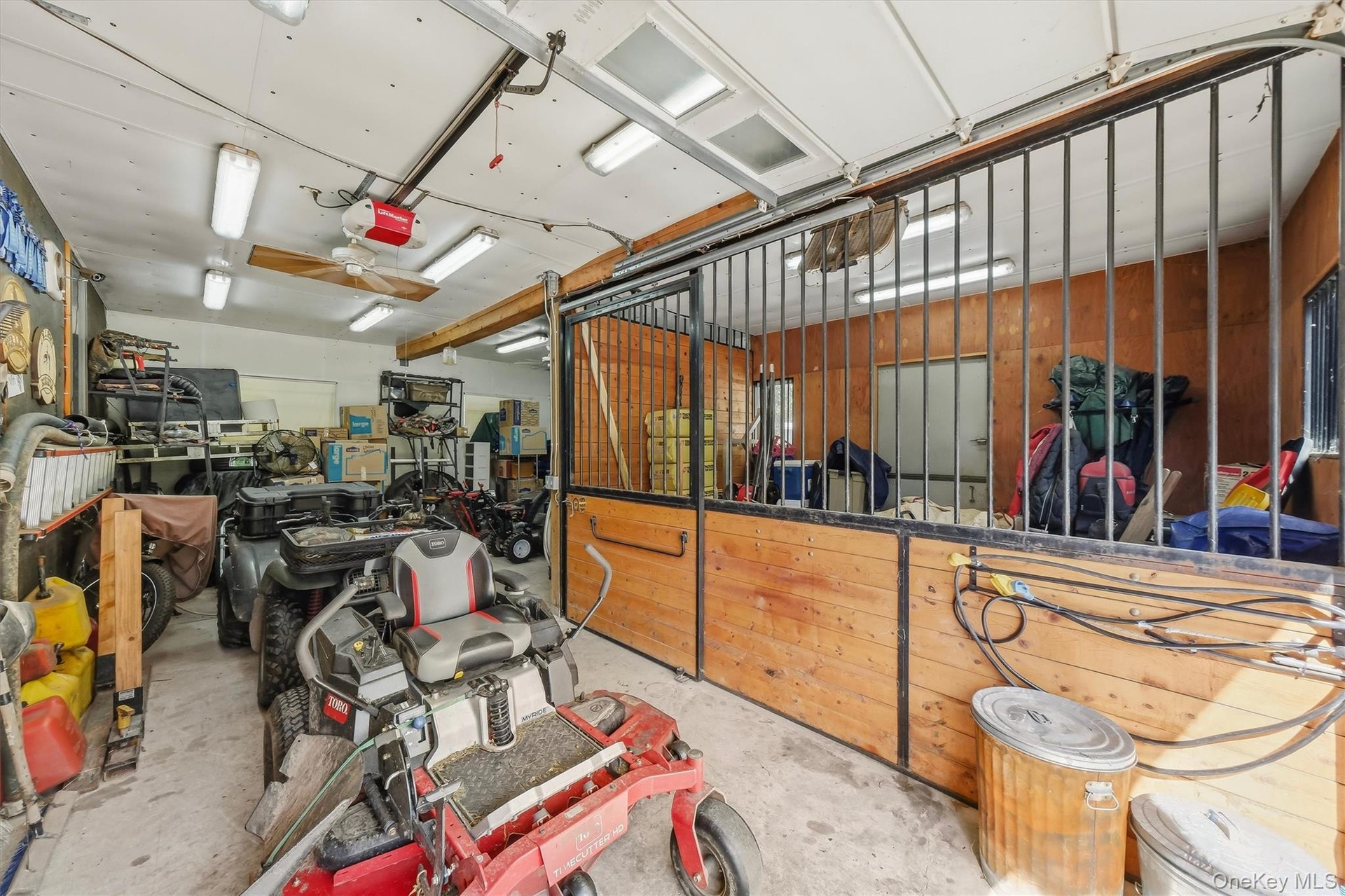 One bay is dedicated to an additional stall and a wash stall, and is separate from the rest of the garage.  The stall has a dutch door to the outside,
