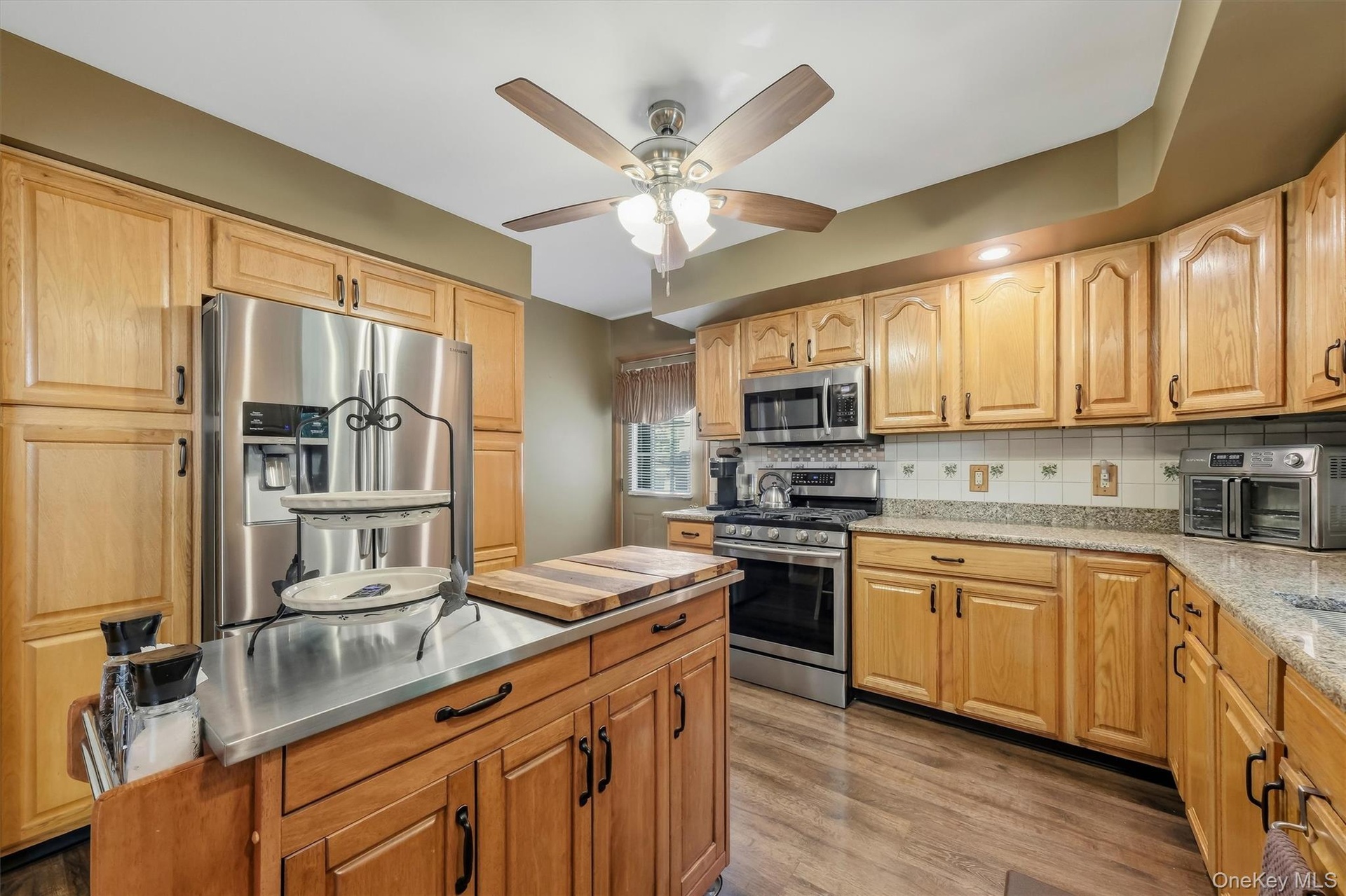 Plenty of quality cabinets, a recessed fridge, enough counter space to prepare a feast, and a side door to the back deck make the kitchen an easy plac