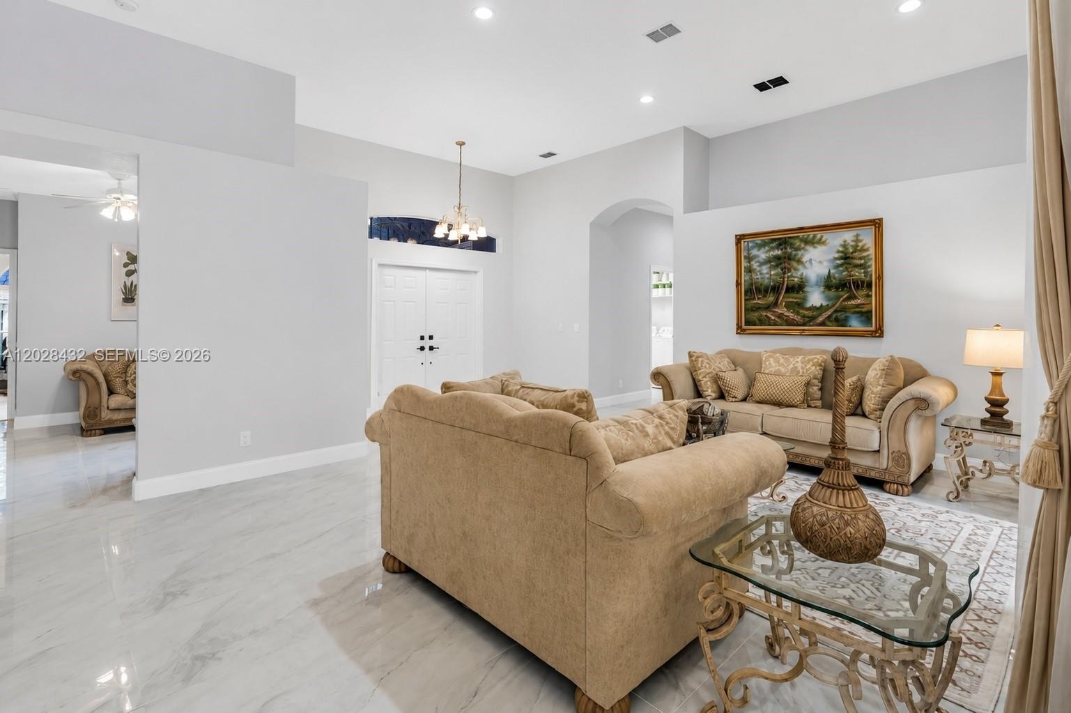 Room featuring neutral wall paint, tile flooring, recessed lighting, a ceiling fan with integrated light fixture, and a window with exterior screen en