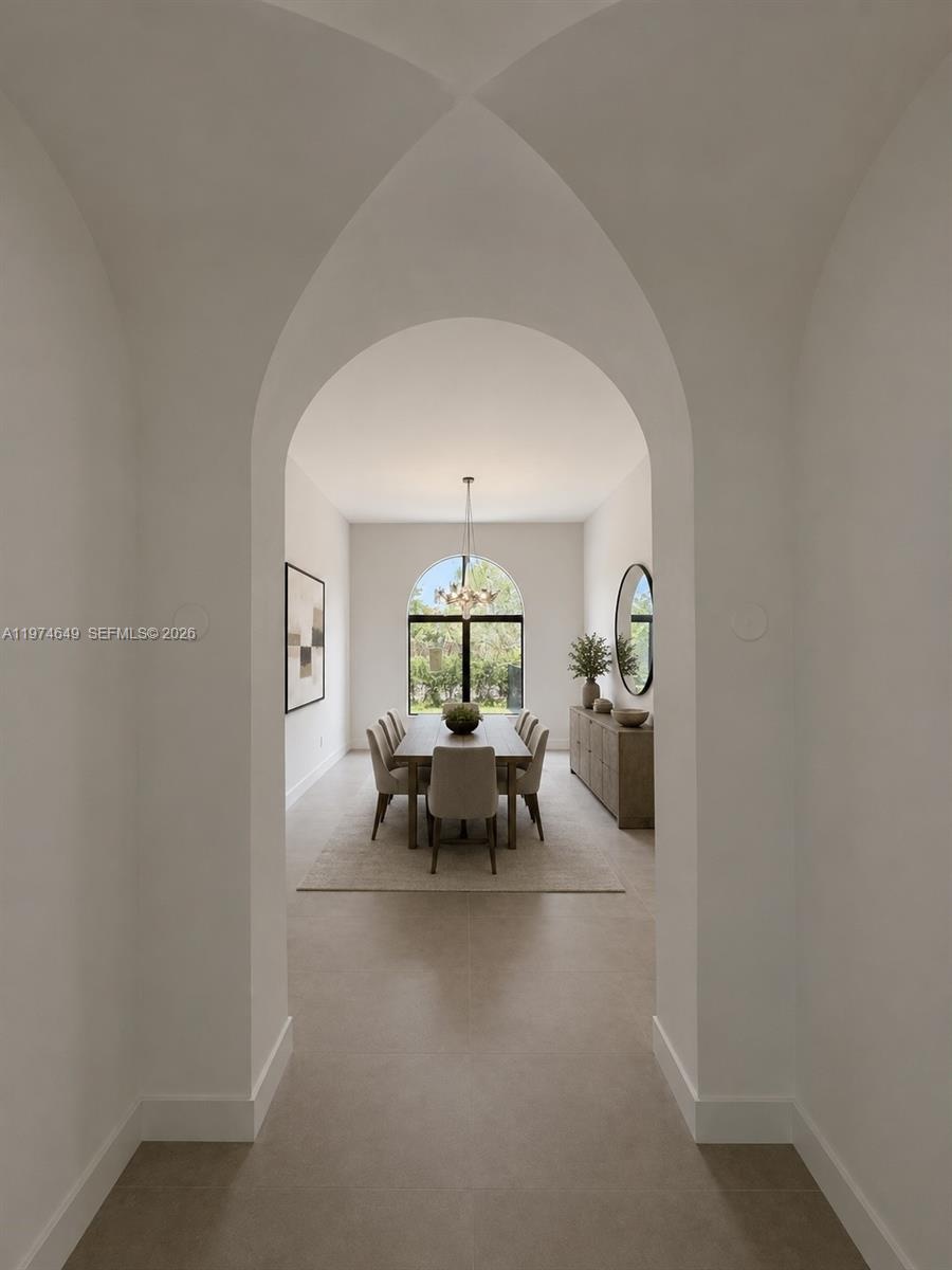 Art passage way from great room to dining room. AI Staged.
