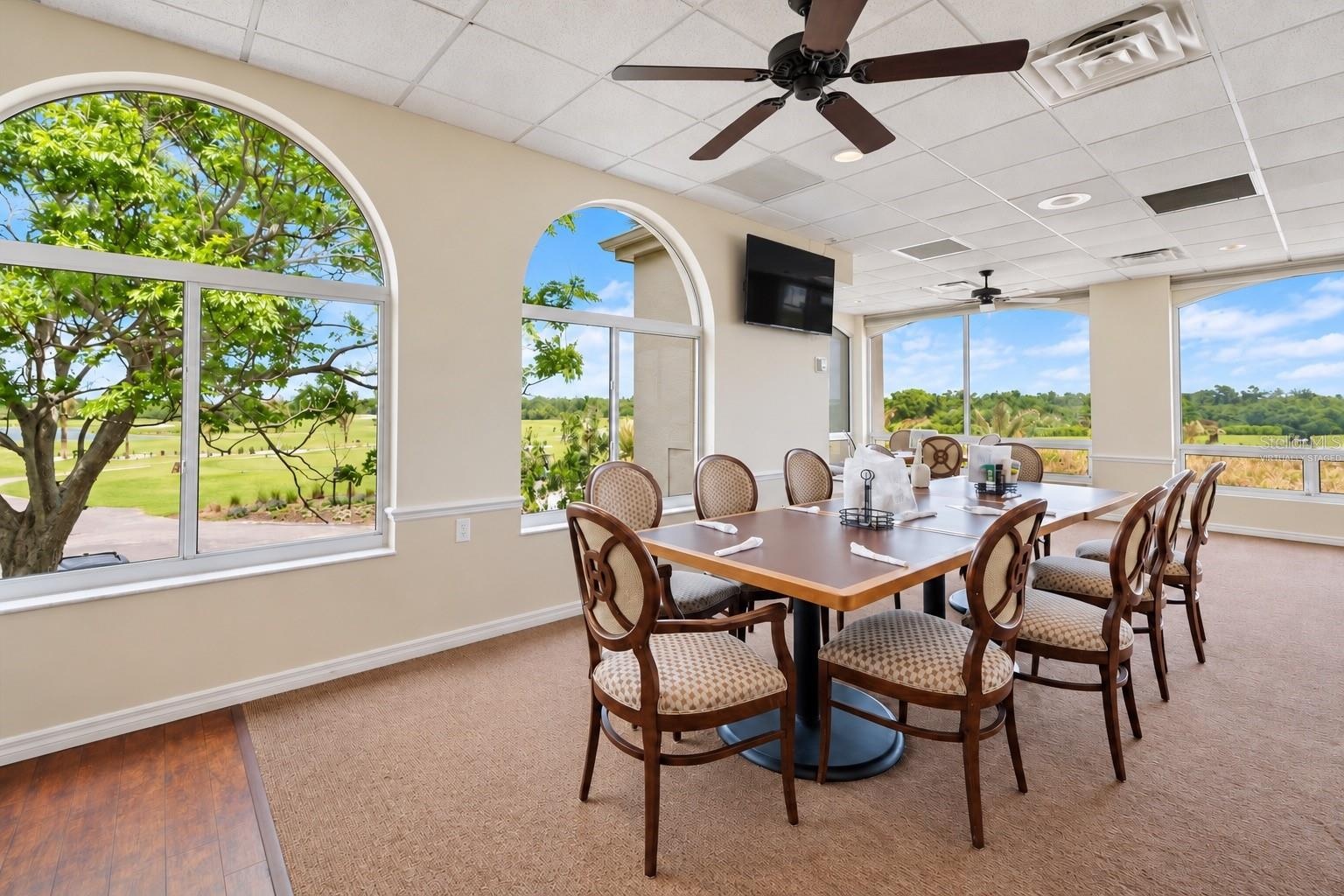 Clubhouse window dining room, virtually staged, condiments removed and TV darkened