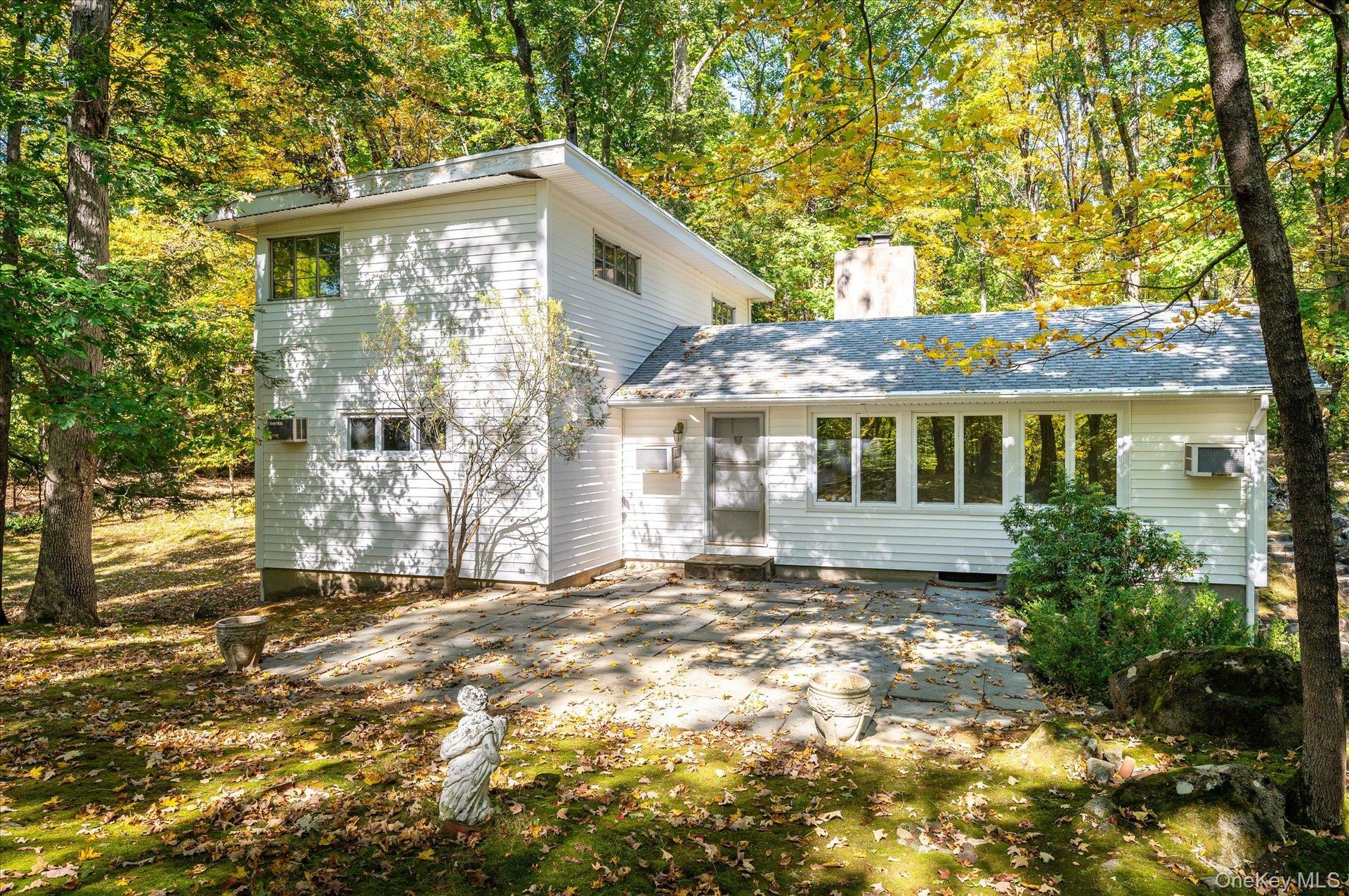 Set back in the woods on over 4 private acres in Huntersville