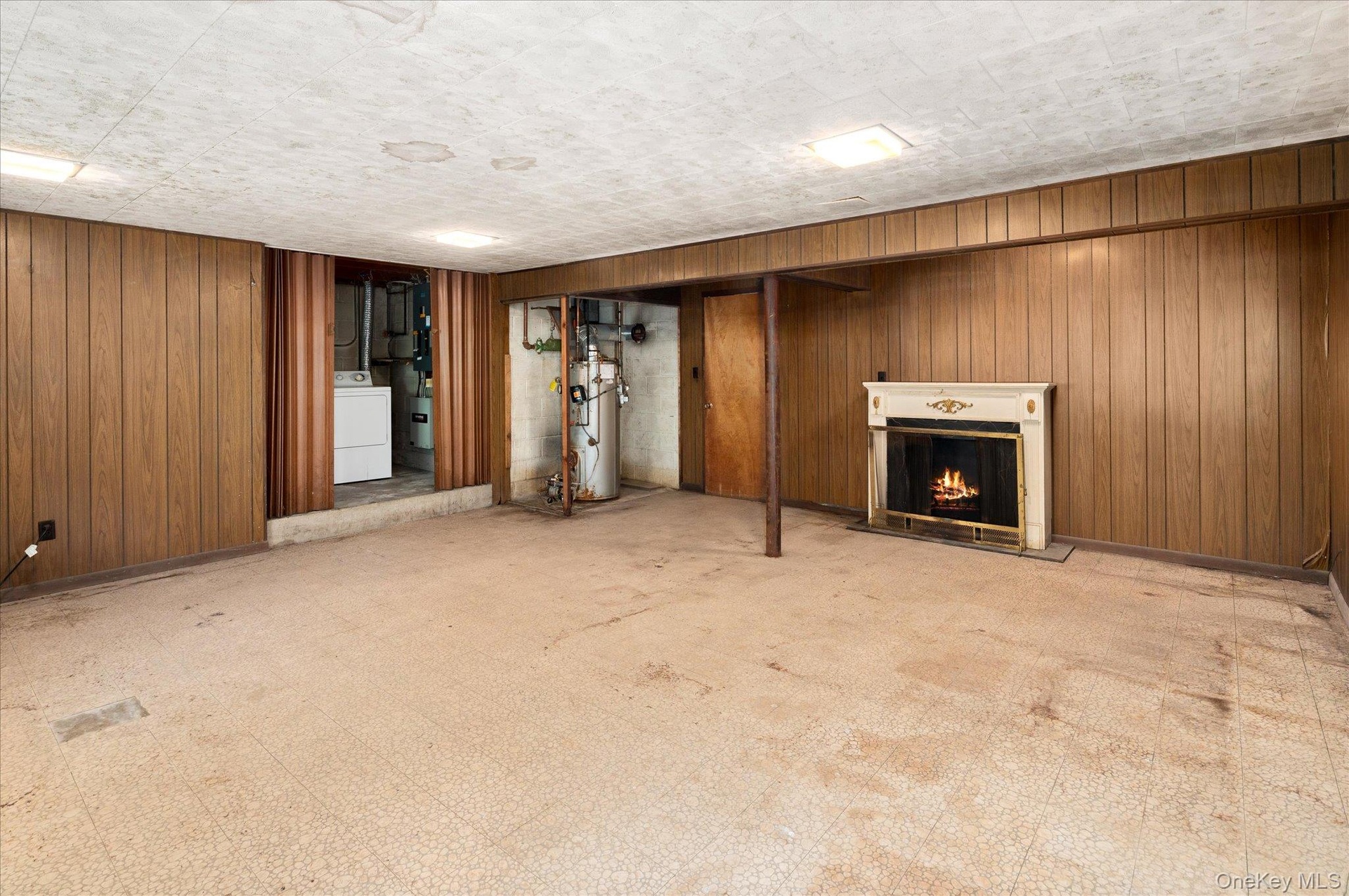 The lower level, with a decorative fireplace and plenty of room