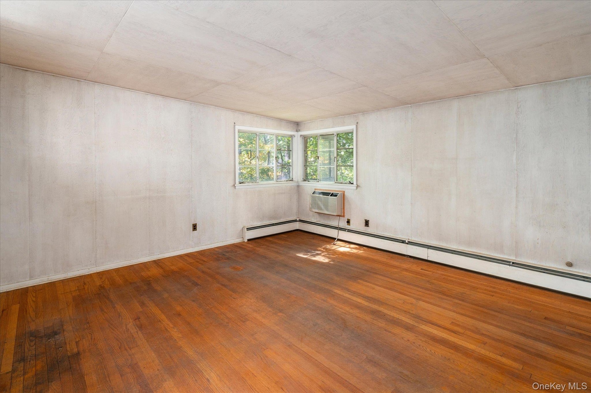 Corner windows open the primary bedroom to the woods