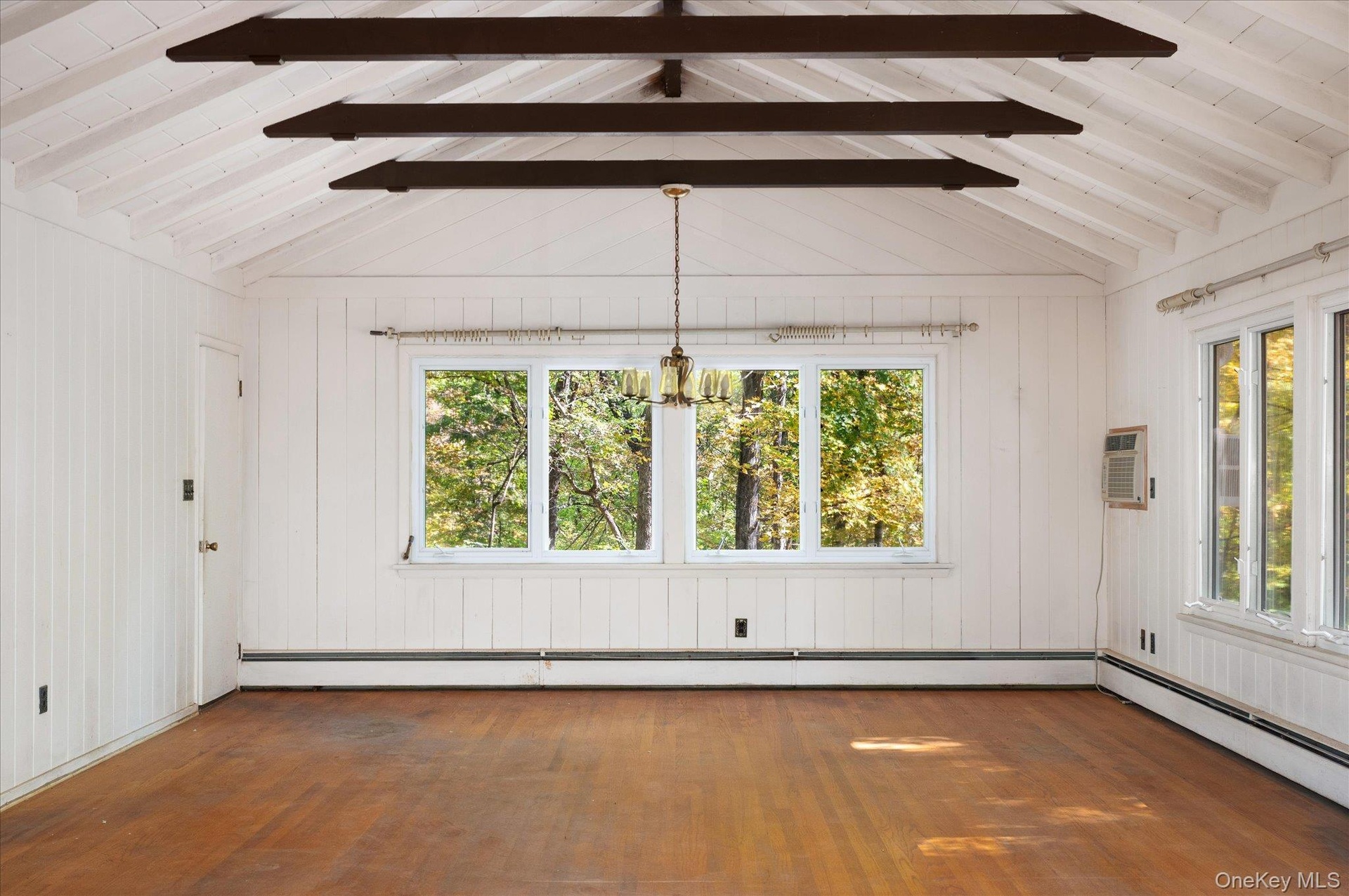 Dining area at the far end of the great room, framed by windows