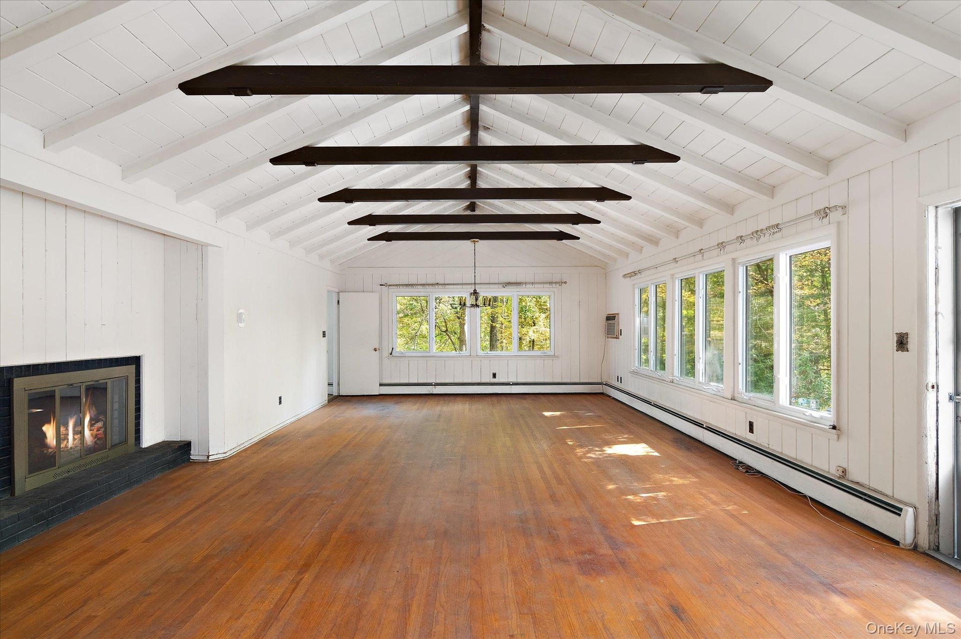 Beams overhead, fire on one end, woods on every side