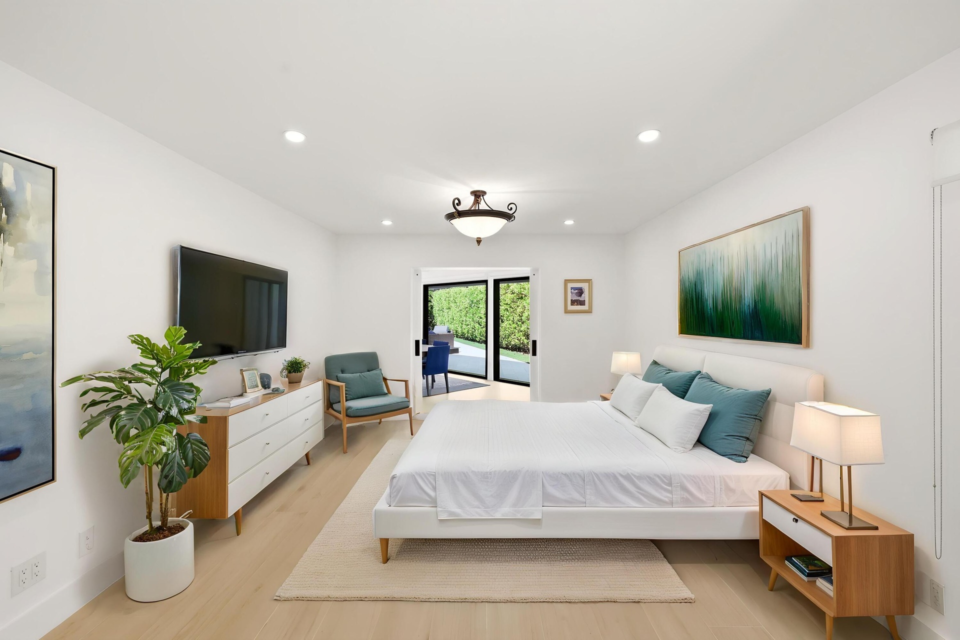 Privately tucked behind contemporary frosted glass barn doors, the primary suite is a tranquil retreat designed for comfort and relaxation. Filled wit
