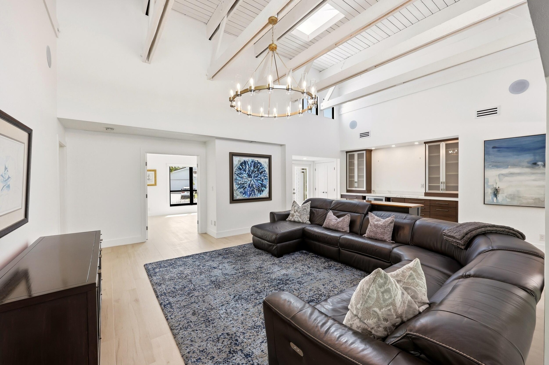 The heart of the home is an extraordinary open concept living space where soaring vaulted ceilings, exposed wood beams, skylights, and walls of hurric