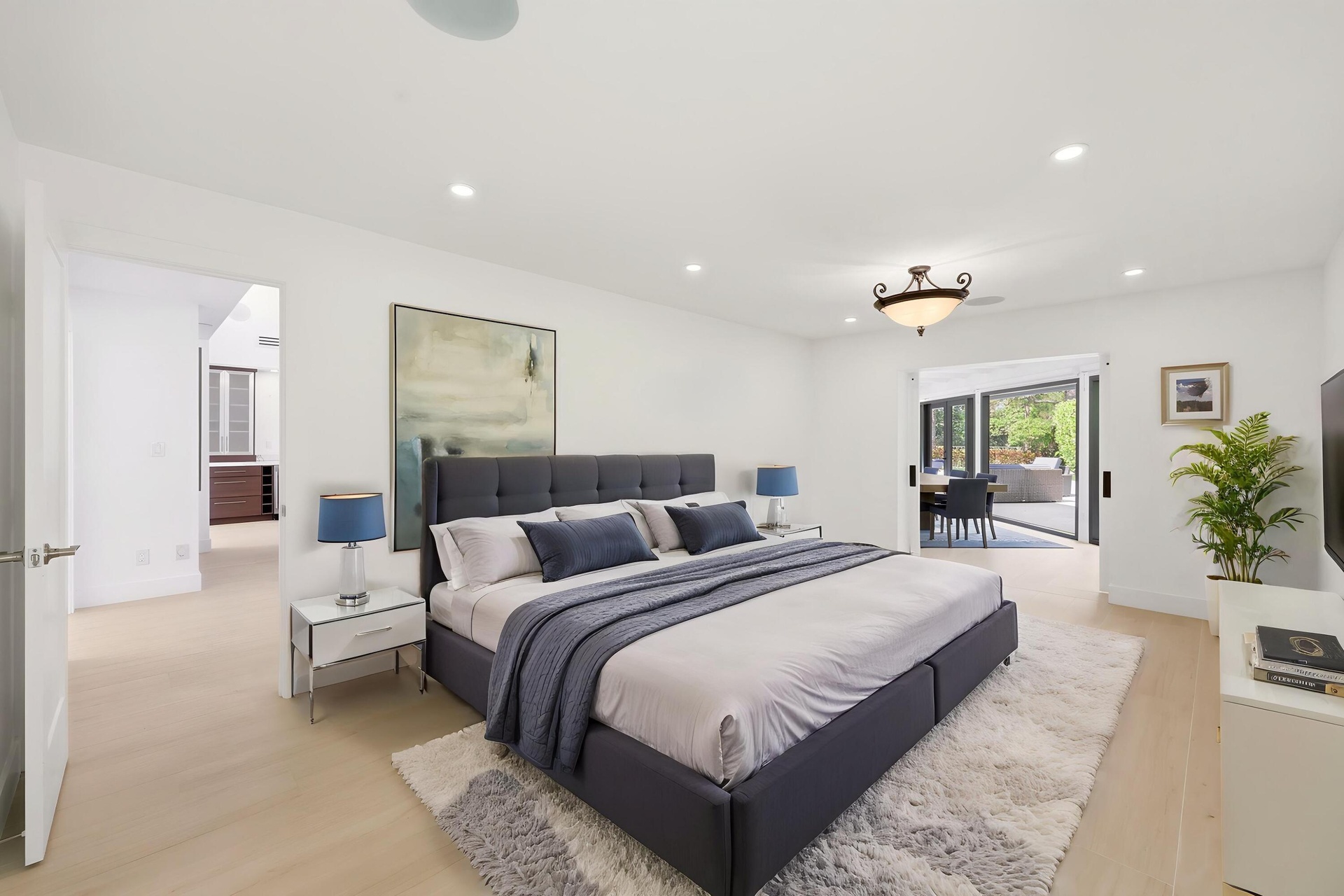 Privately tucked behind contemporary frosted glass barn doors, the primary suite is a tranquil retreat designed for comfort and relaxation. Filled wit