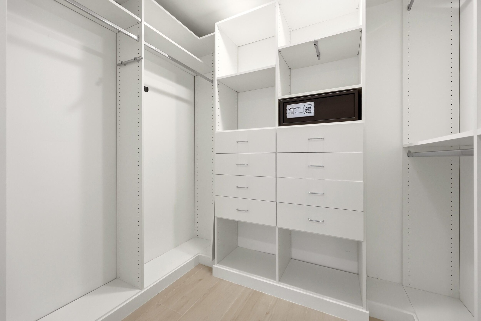 Designed for organization and convenience, this custom walk-in closet offers an impressive amount of storage with built-in shelving, abundant hanging 