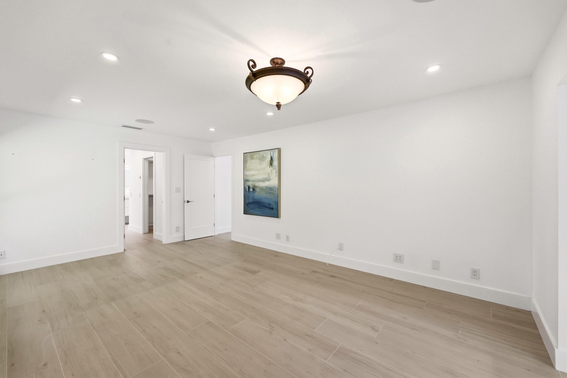 Privately tucked behind contemporary frosted glass barn doors, the primary suite is a tranquil retreat designed for comfort and relaxation. Filled wit