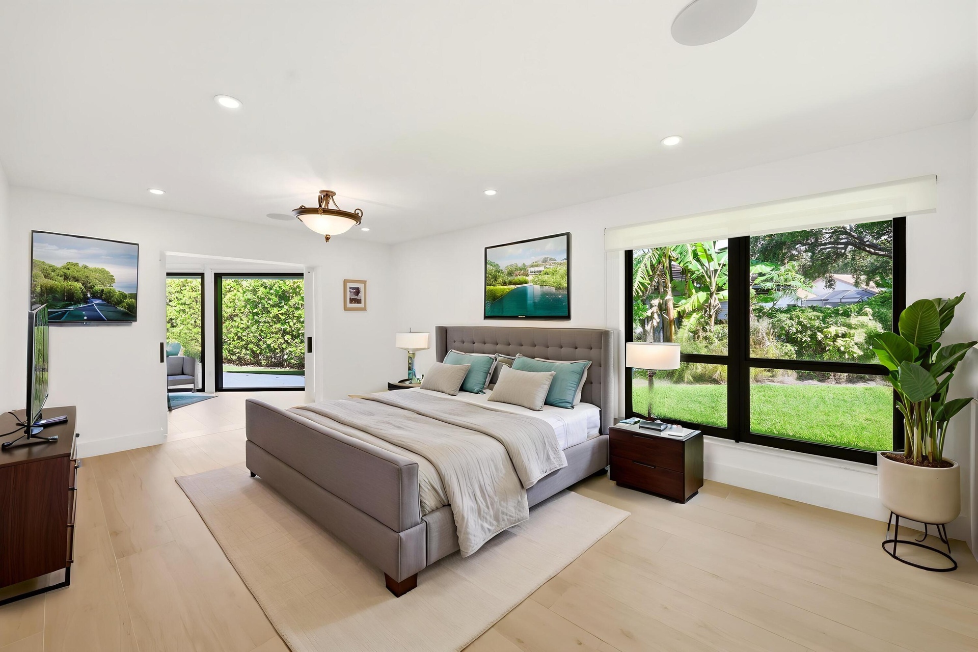 Privately tucked behind contemporary frosted glass barn doors, the primary suite is a tranquil retreat designed for comfort and relaxation. Filled wit