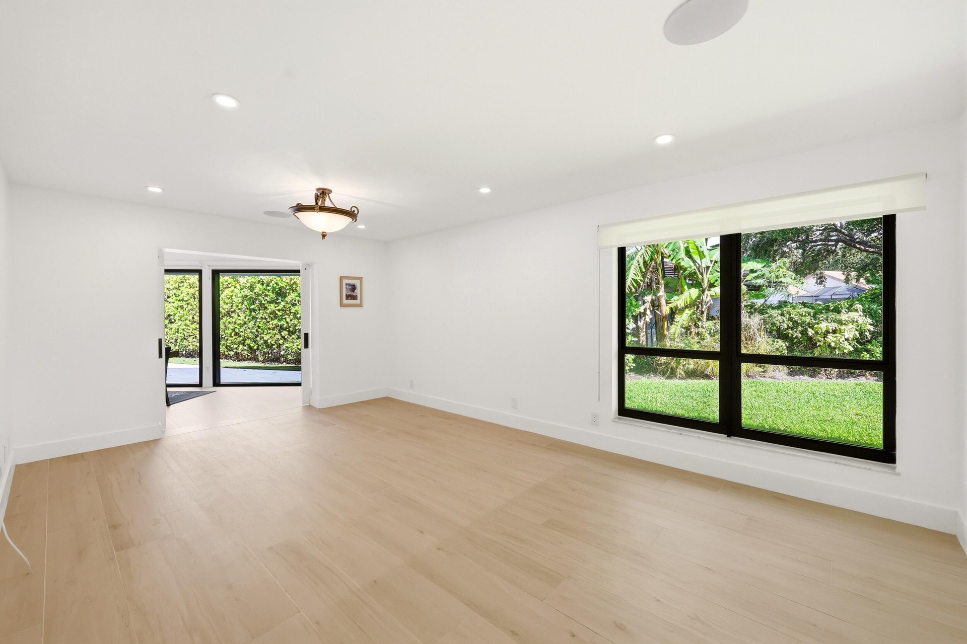 Privately tucked behind contemporary frosted glass barn doors, the primary suite is a tranquil retreat designed for comfort and relaxation. Filled wit