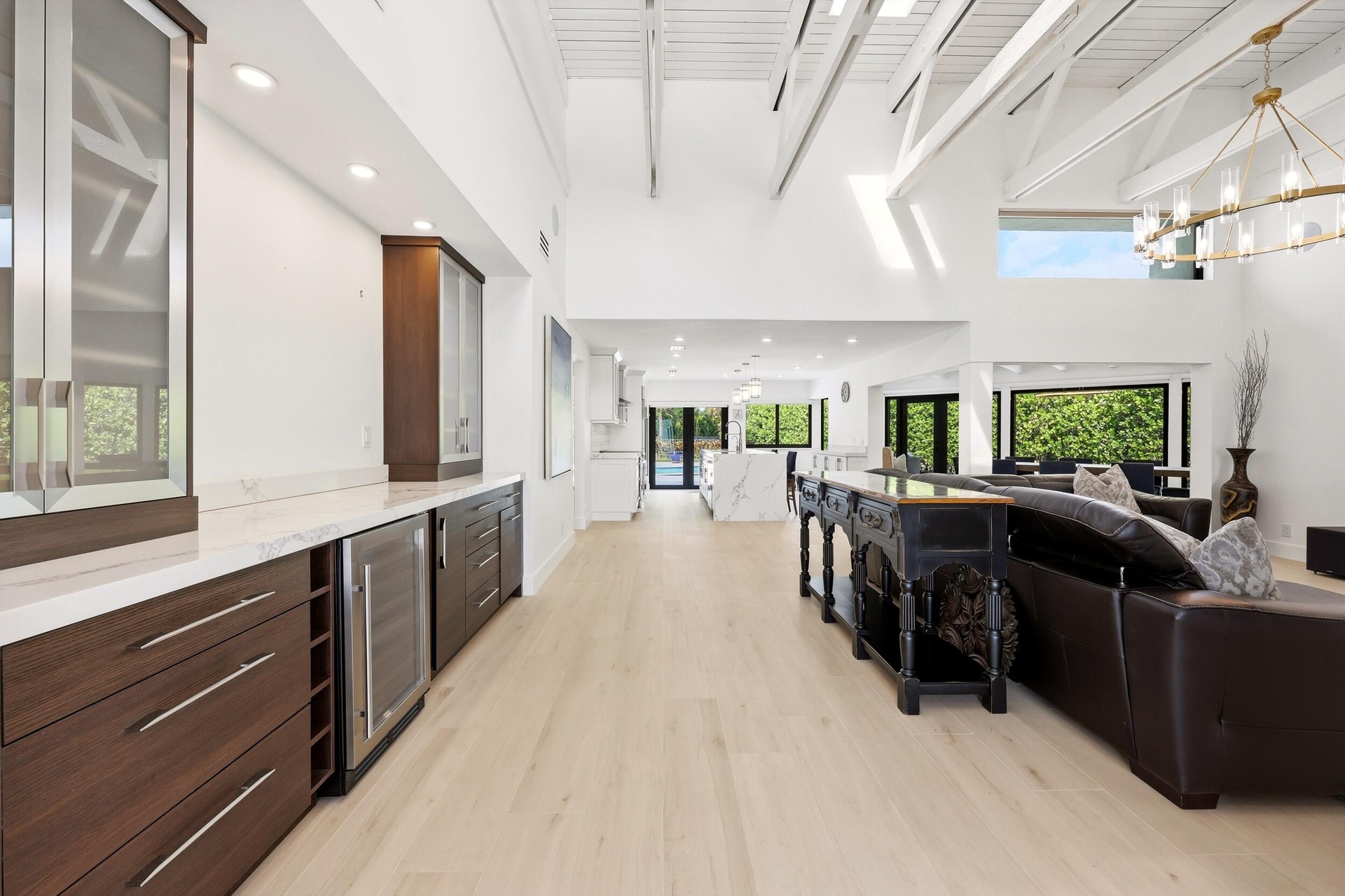 The heart of the home is an extraordinary open concept living space where soaring vaulted ceilings, exposed wood beams, skylights, and walls of hurric