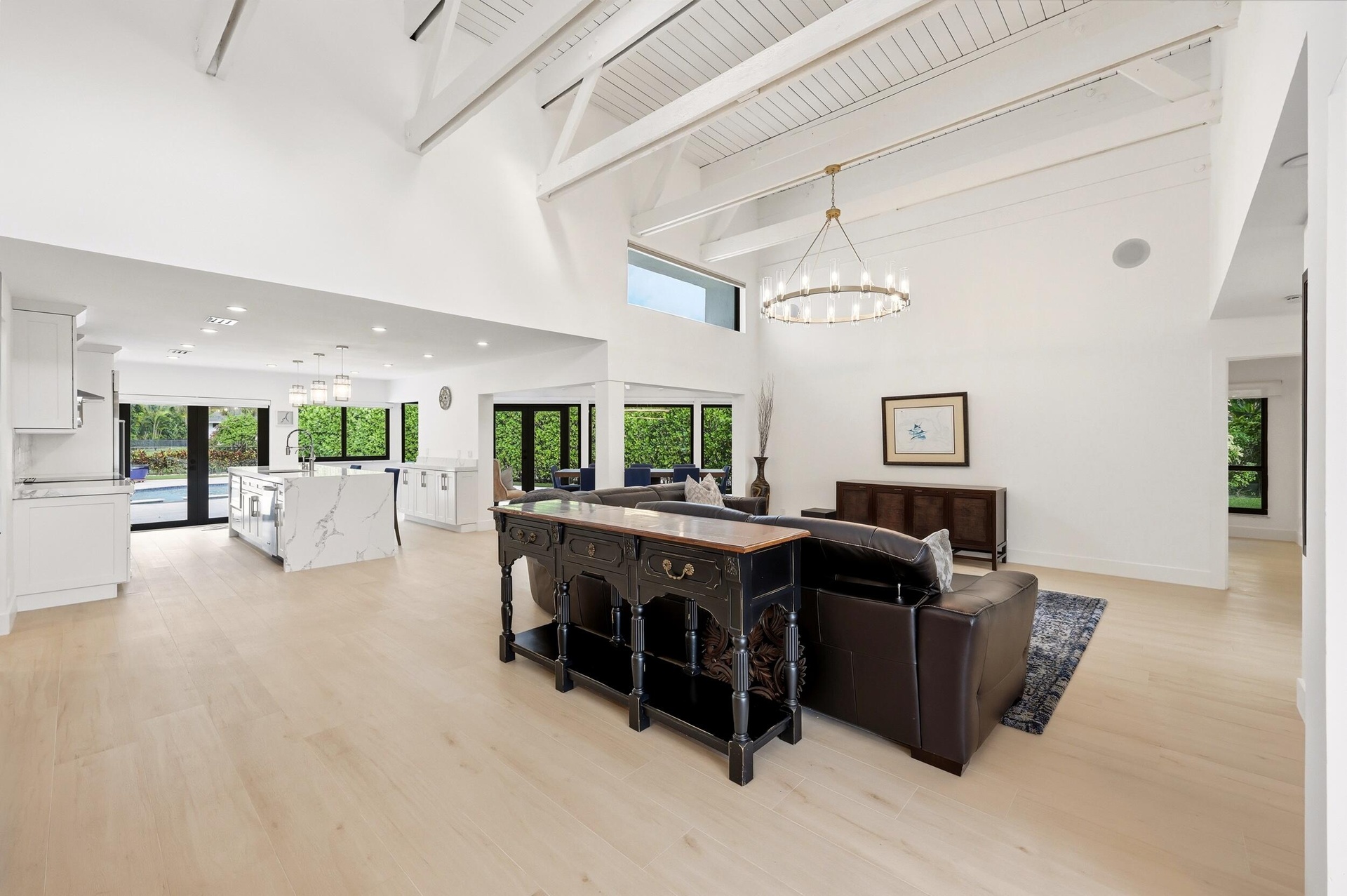 The heart of the home is an extraordinary open concept living space where soaring vaulted ceilings, exposed wood beams, skylights, and walls of hurric