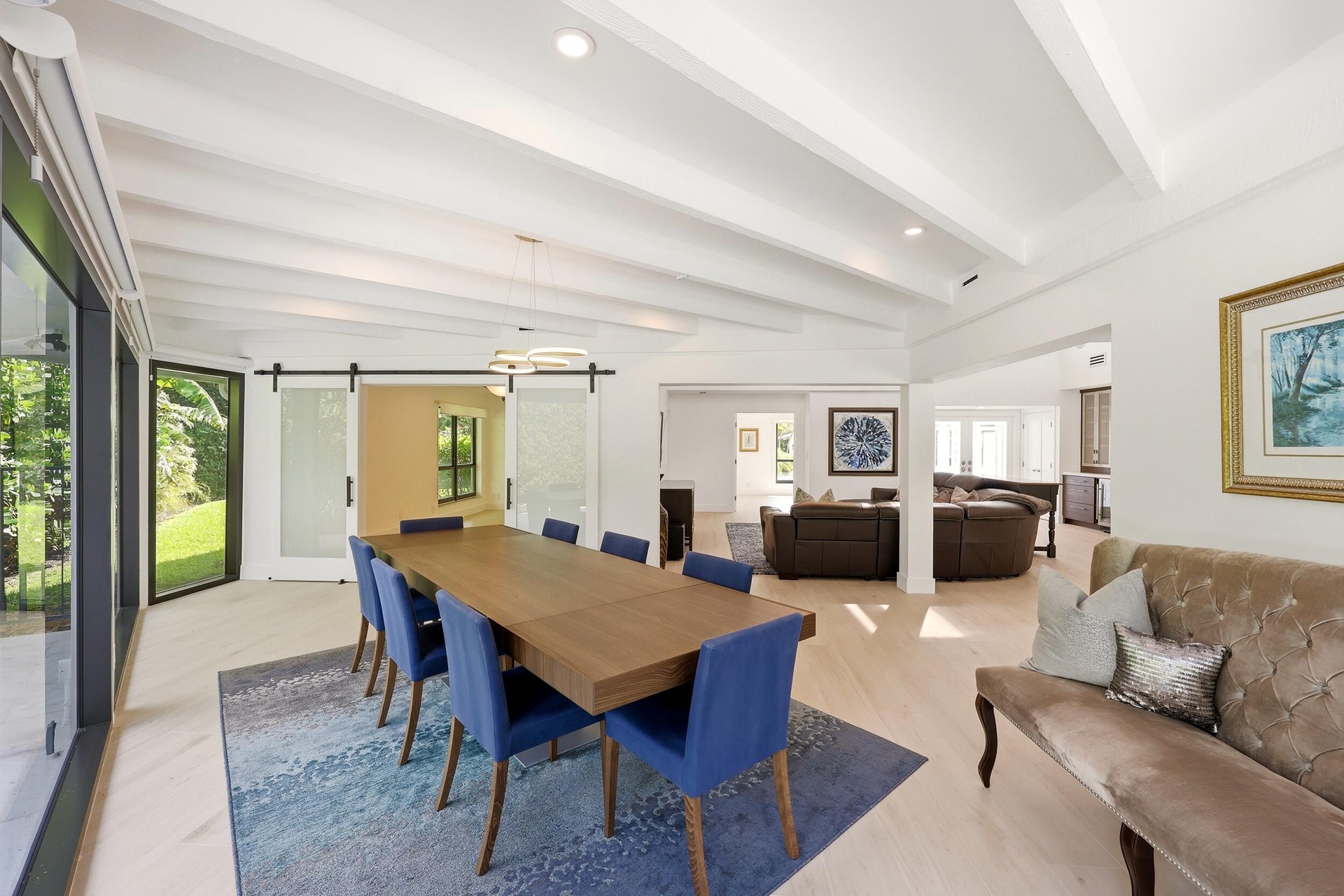 Framed by walls of hurricane impact glass and tranquil views of the pool and lush preserve beyond, the dining room offers an unforgettable setting for