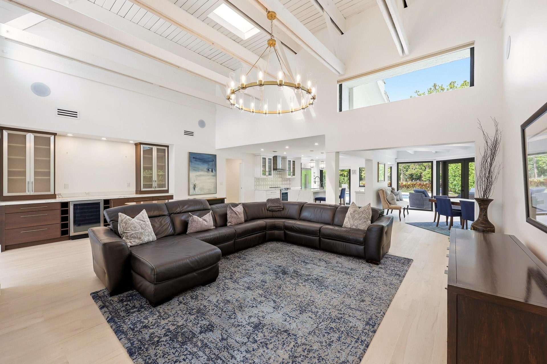The heart of the home is an extraordinary open concept living space where soaring vaulted ceilings, exposed wood beams, skylights, and walls of hurric