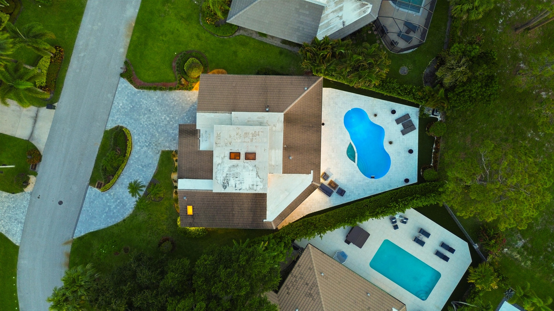 From above, the true rarity of this property comes into focus. Perfectly positioned on an oversized cul de sac lot, the home backs directly to a prote
