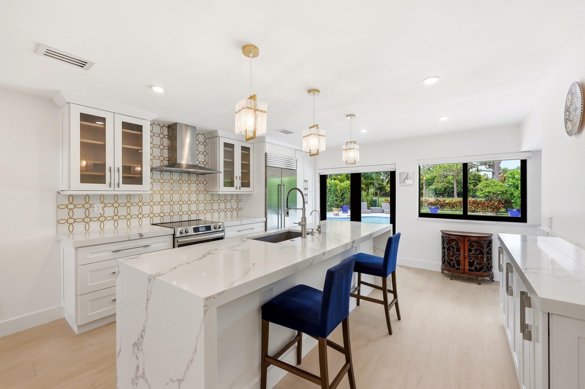 The heart of the home is an impressive open-concept living space defined by soaring vaulted ceilings, exposed beams, skylights, and an abundance of na
