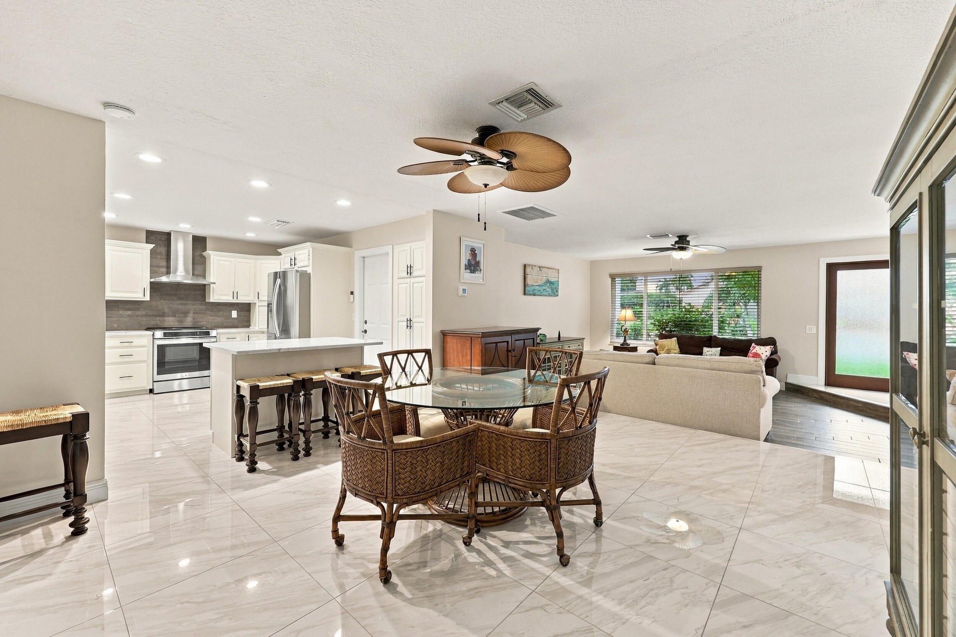 The dining space and eat-in kitchen are highlighted by new floors and a beautifully updated kitchen with quartz countertops and stainless steel applia