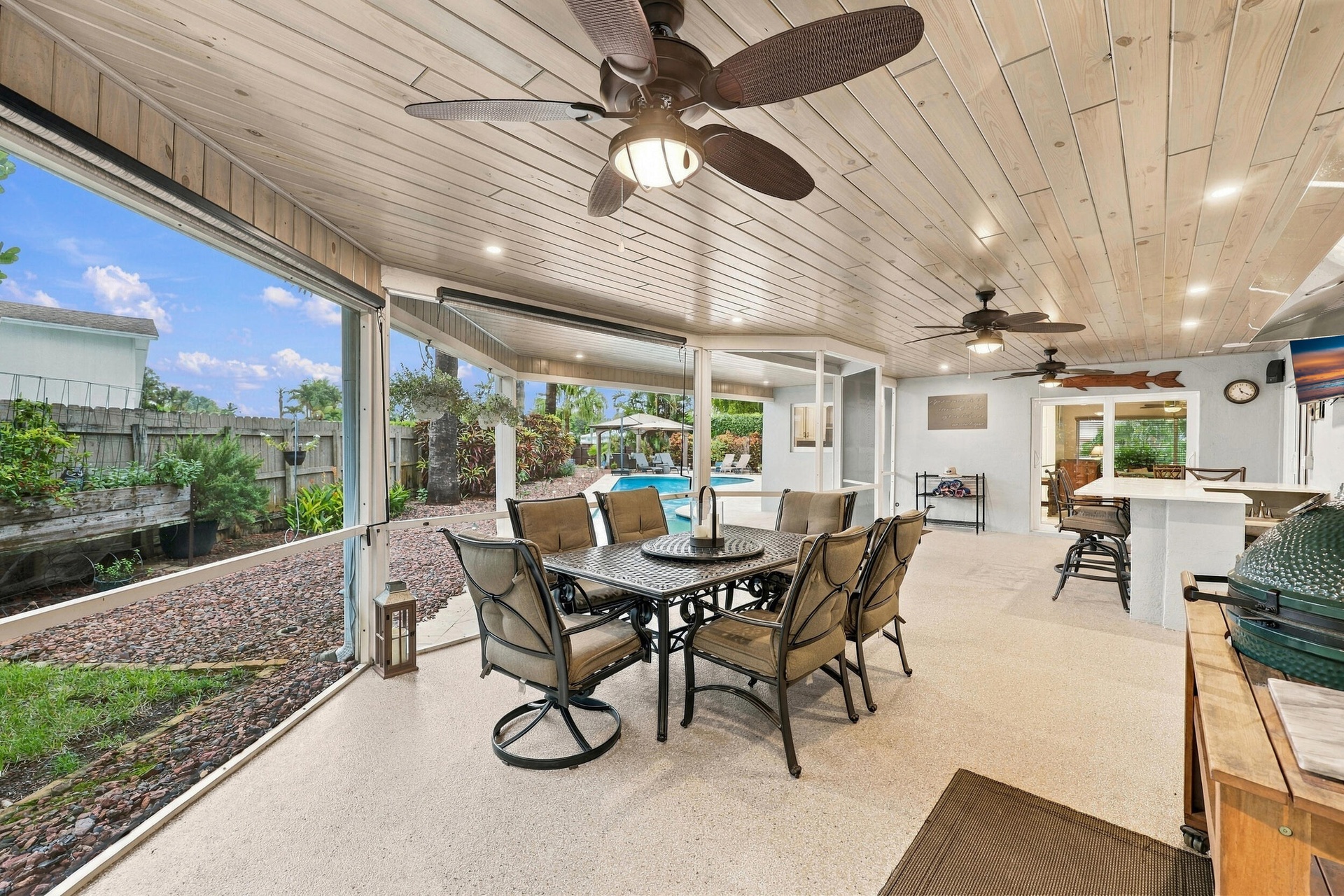 Live the epitome of the South Florida lifestyle with this 1,360 sq. ft. patio. It offers a built-in bar with quartz countertops, a grill area with hoo