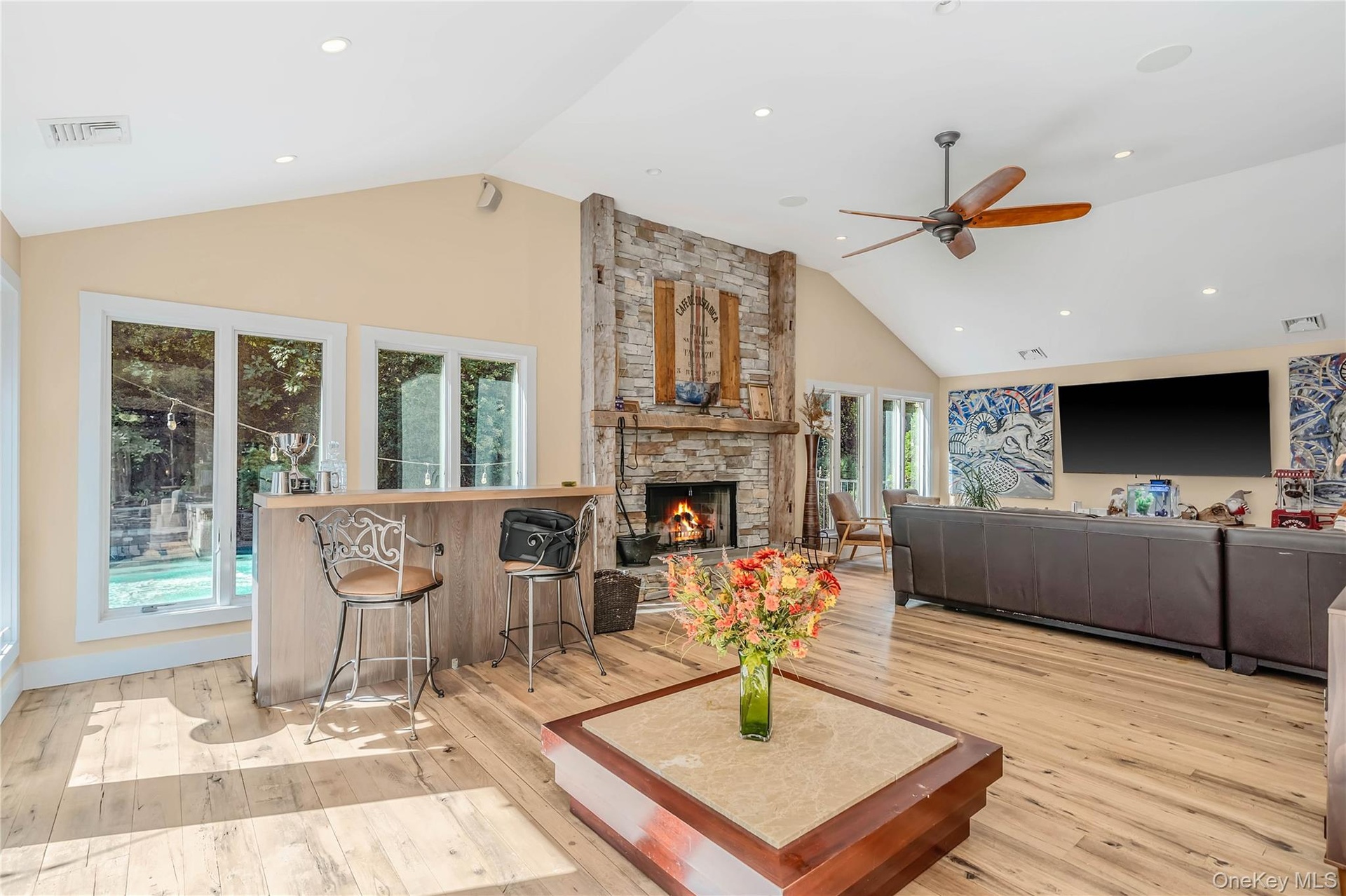 Stone fireplace, wood floors, recessed lighting