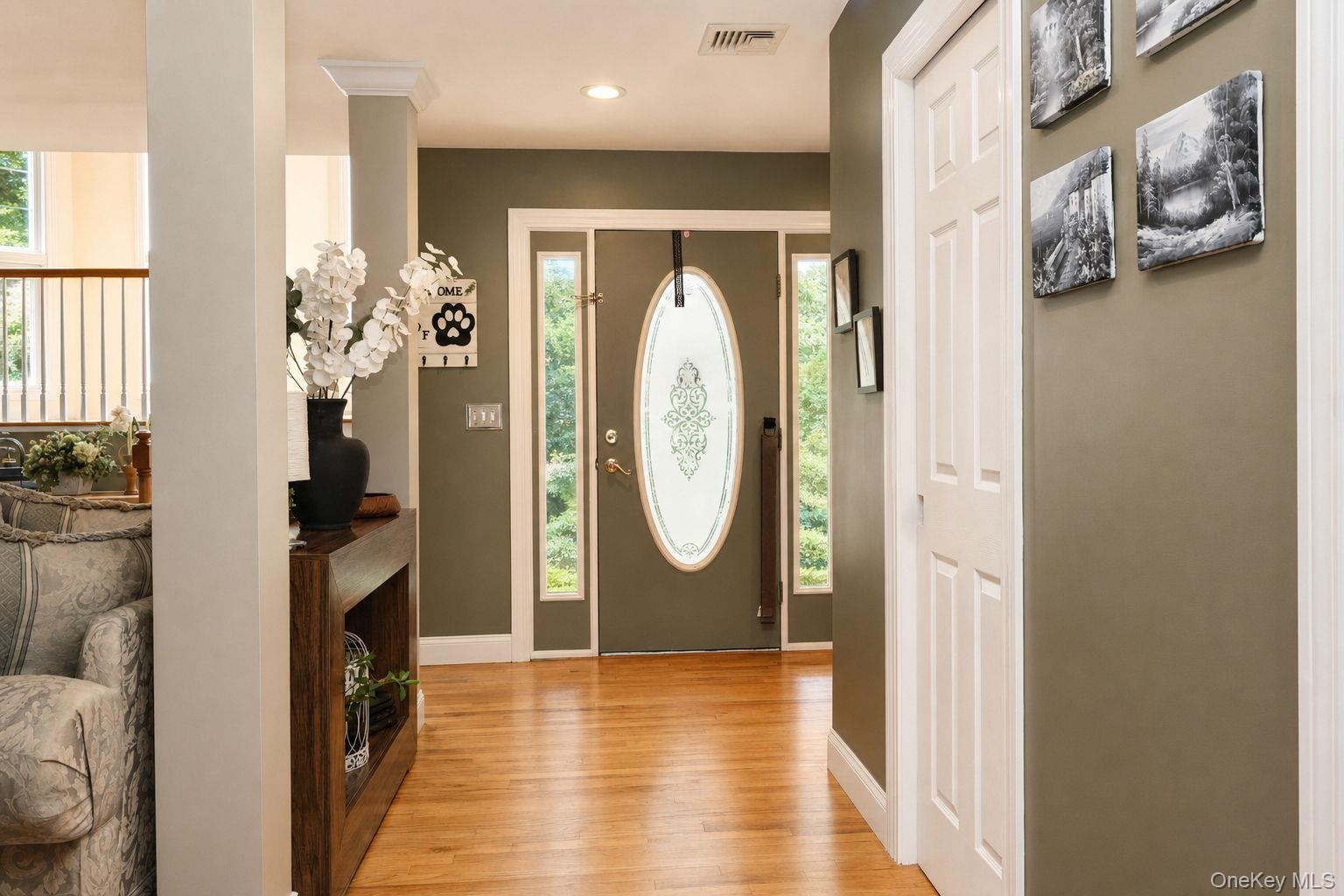 Entry with hardwood flooring, recessed lighting, 6 panel doors, decorative oval glass front entry, side light windows