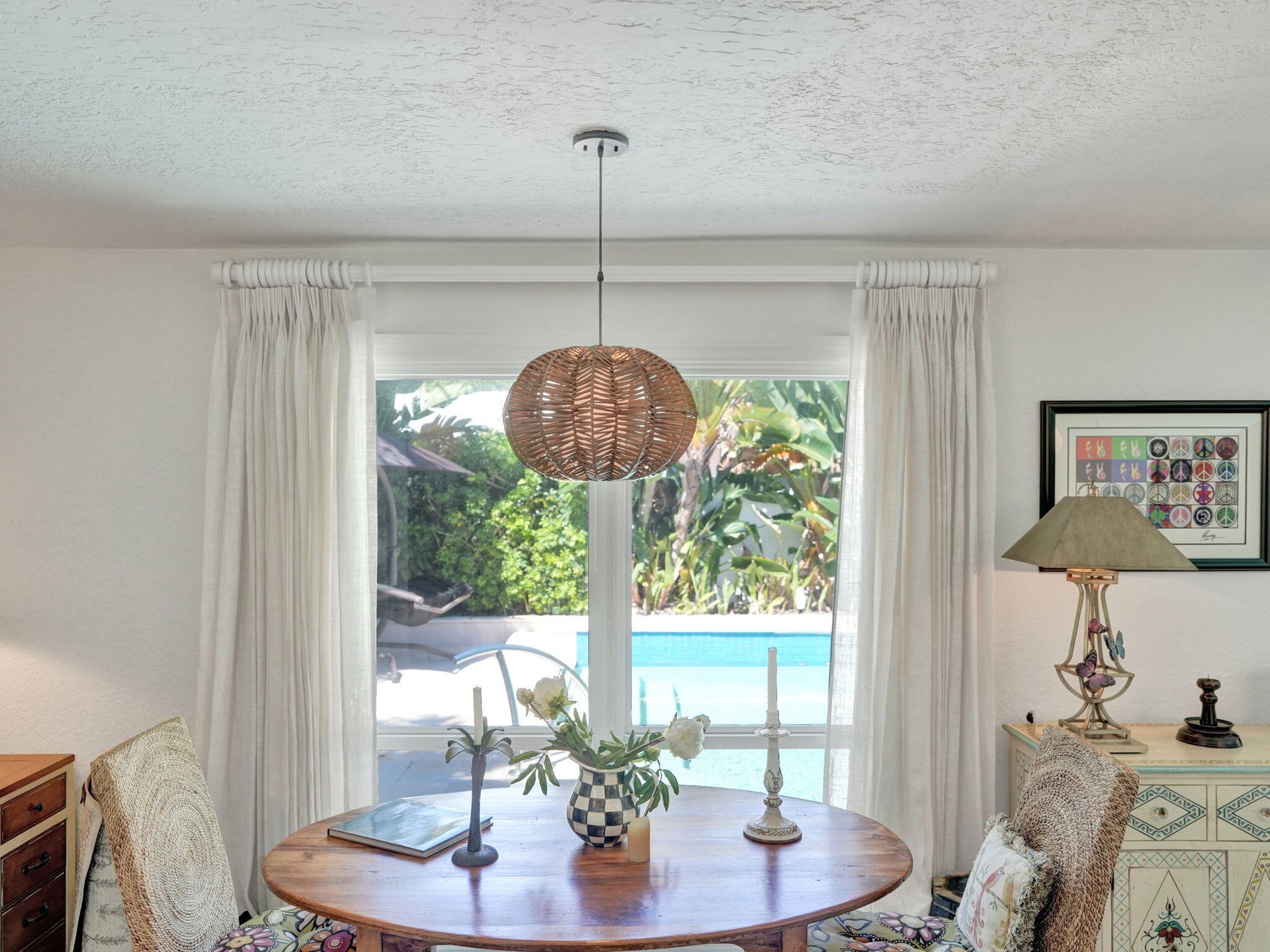 Casual Breakfast area/office space overlooks pool and mature landscaping.