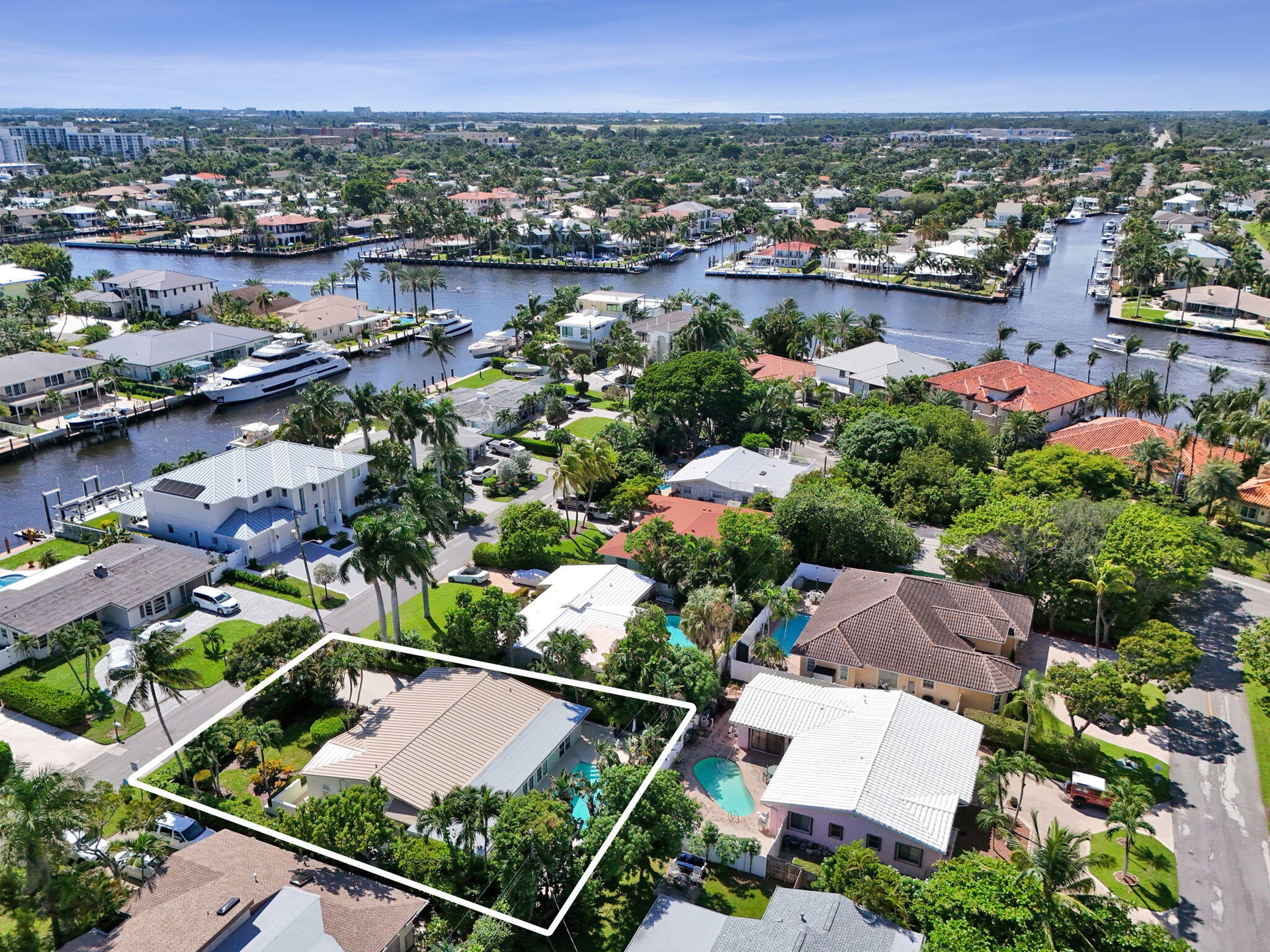 Expansive property featuring a private swimming pool, mature landscaping, and an attached garage