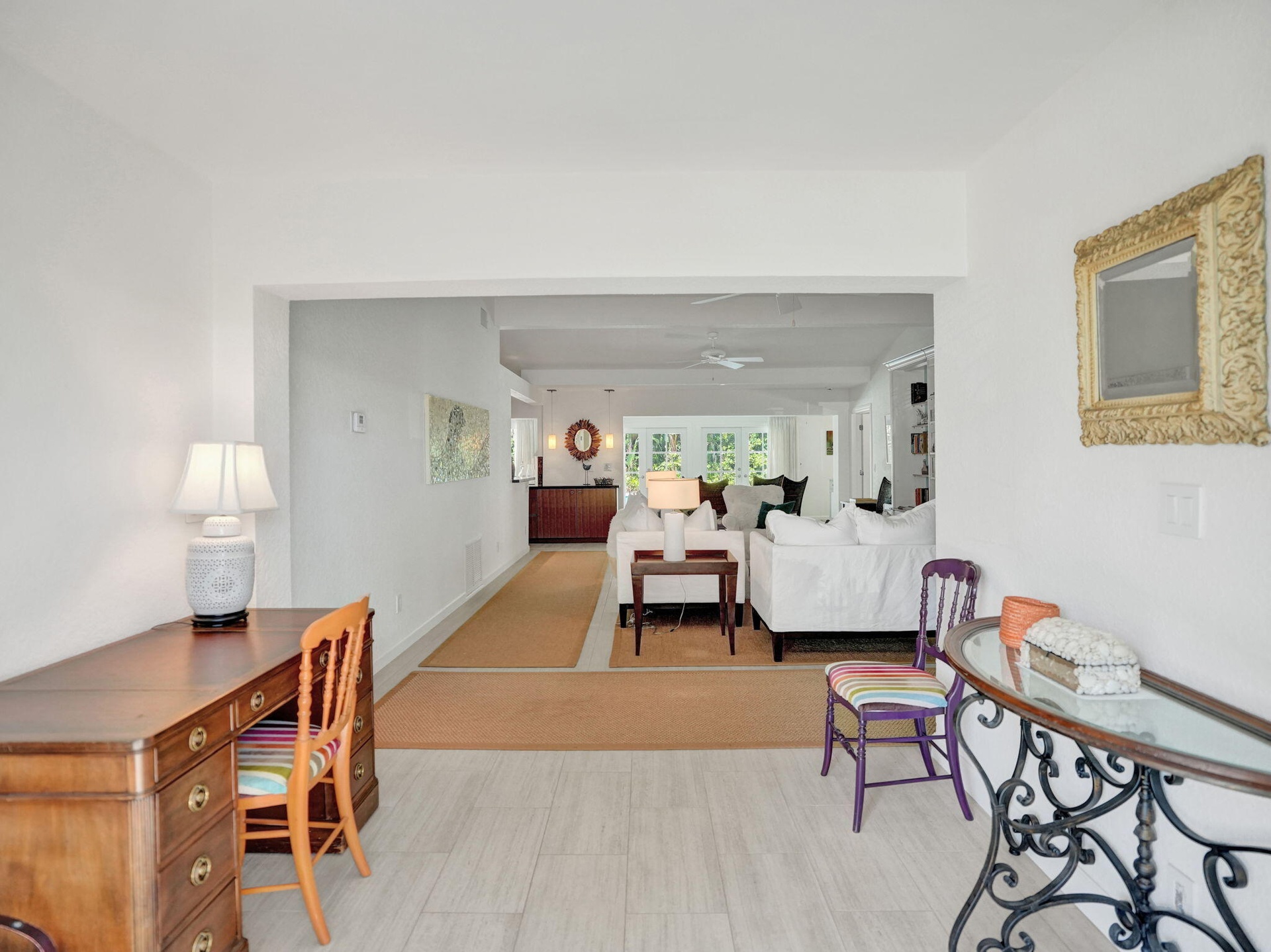 Light tile flooring extending into an open-concept living area.
