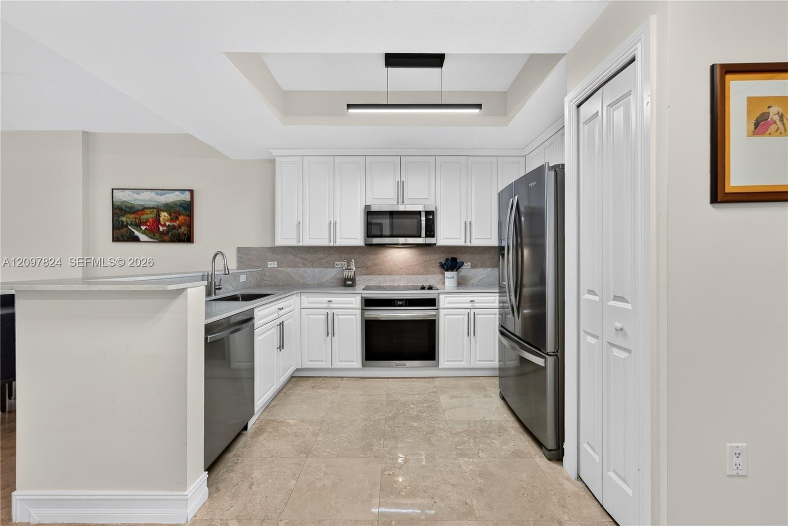 Updated kitchen with quartz counters, new appliances, designer lighting