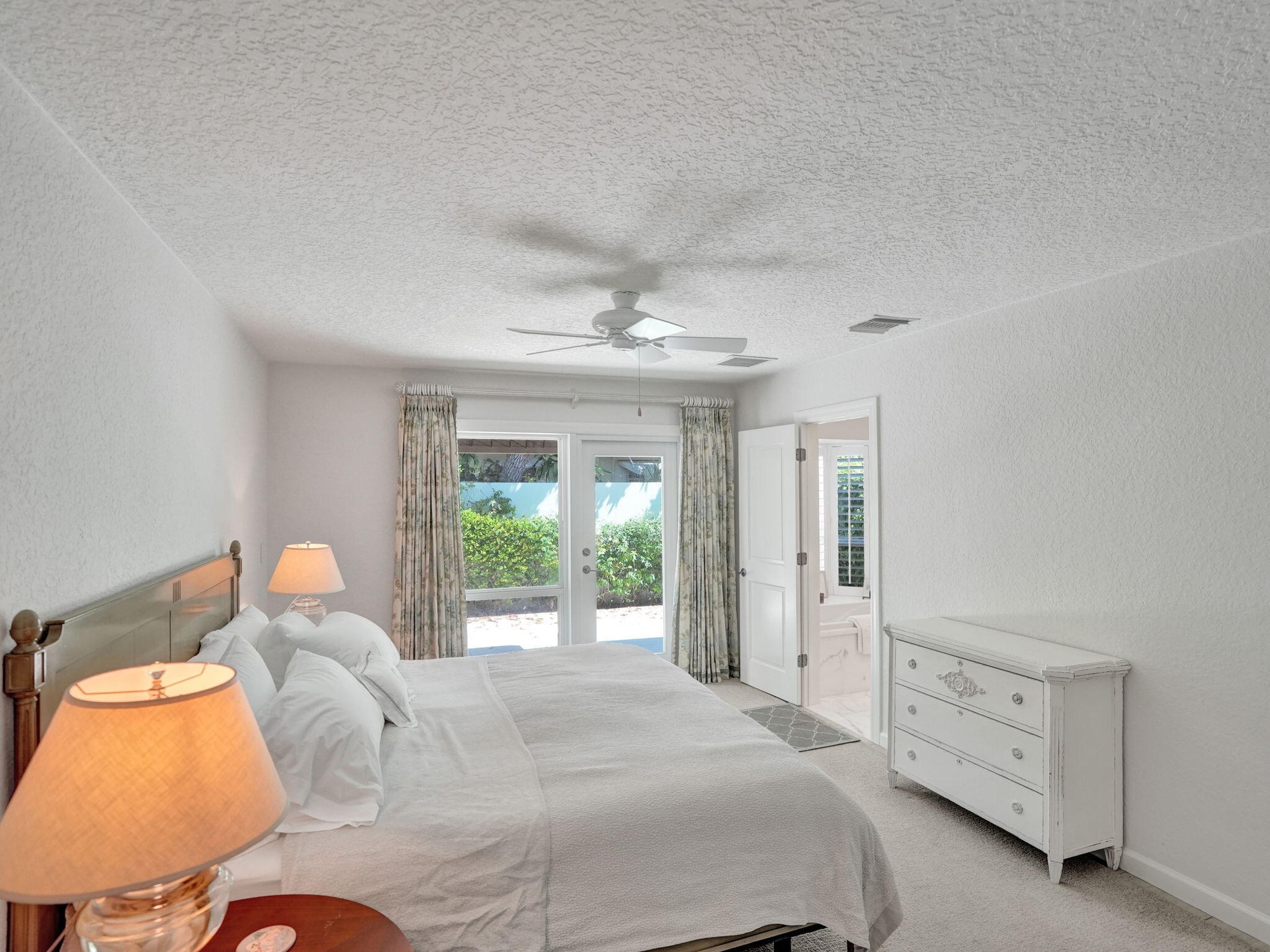 Spacious Master Bedroom with double door access to a private patio retreat.