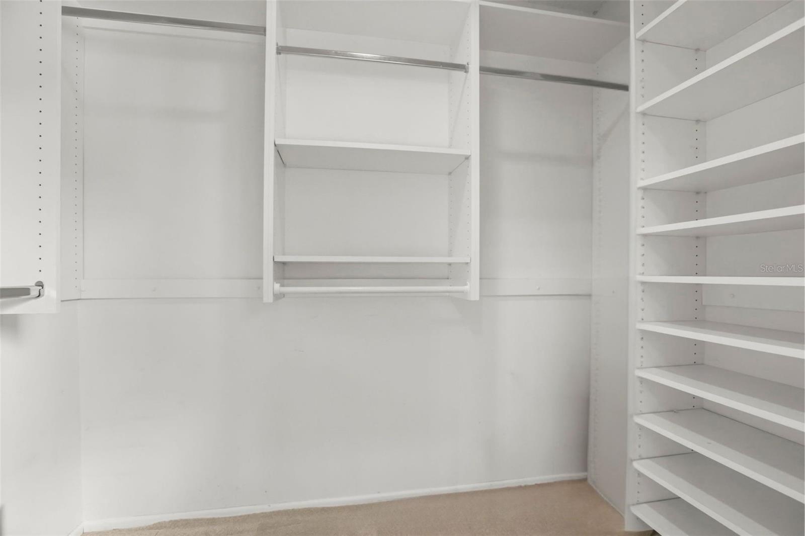The primary suite features a vast walk-in closet enhanced with custom wall unit storage units.