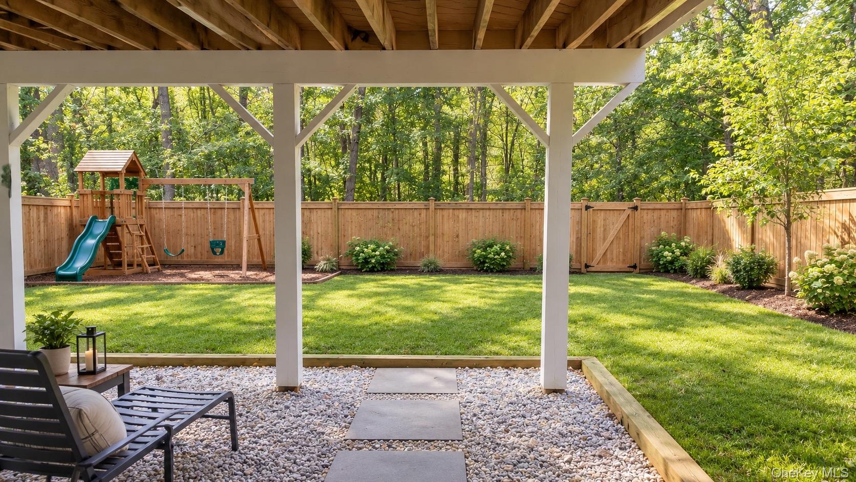 Imagine the possibilities! A beautifully landscaped, fenced-in backyard with room for play, outdoor fun, and making lasting memories. (AI-generated re